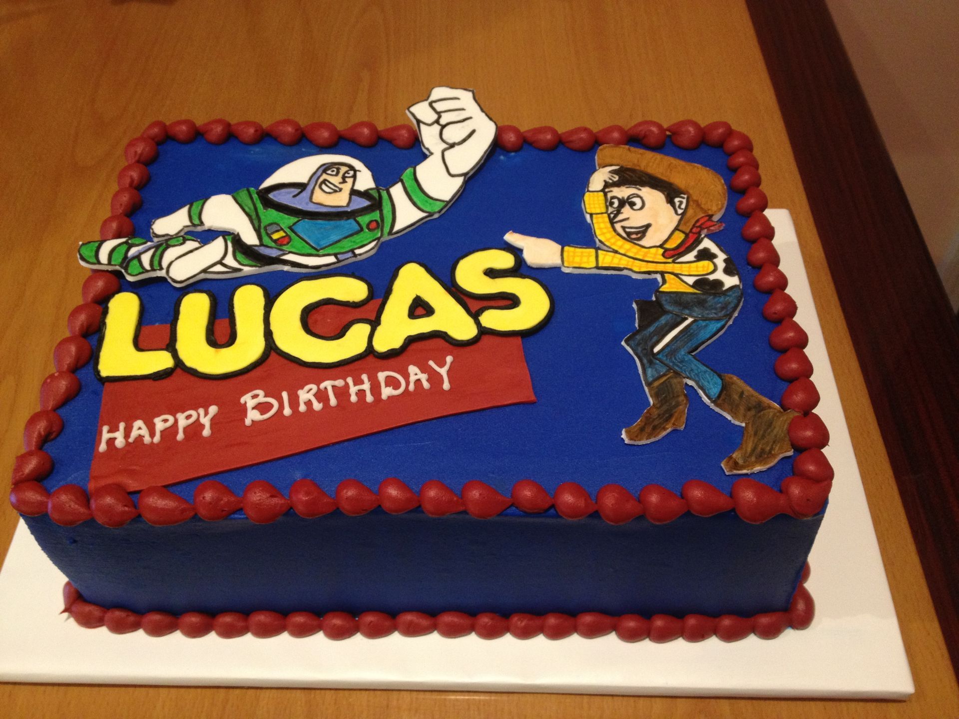 a birthday cake for lucas with buzz lightyear and woody on it