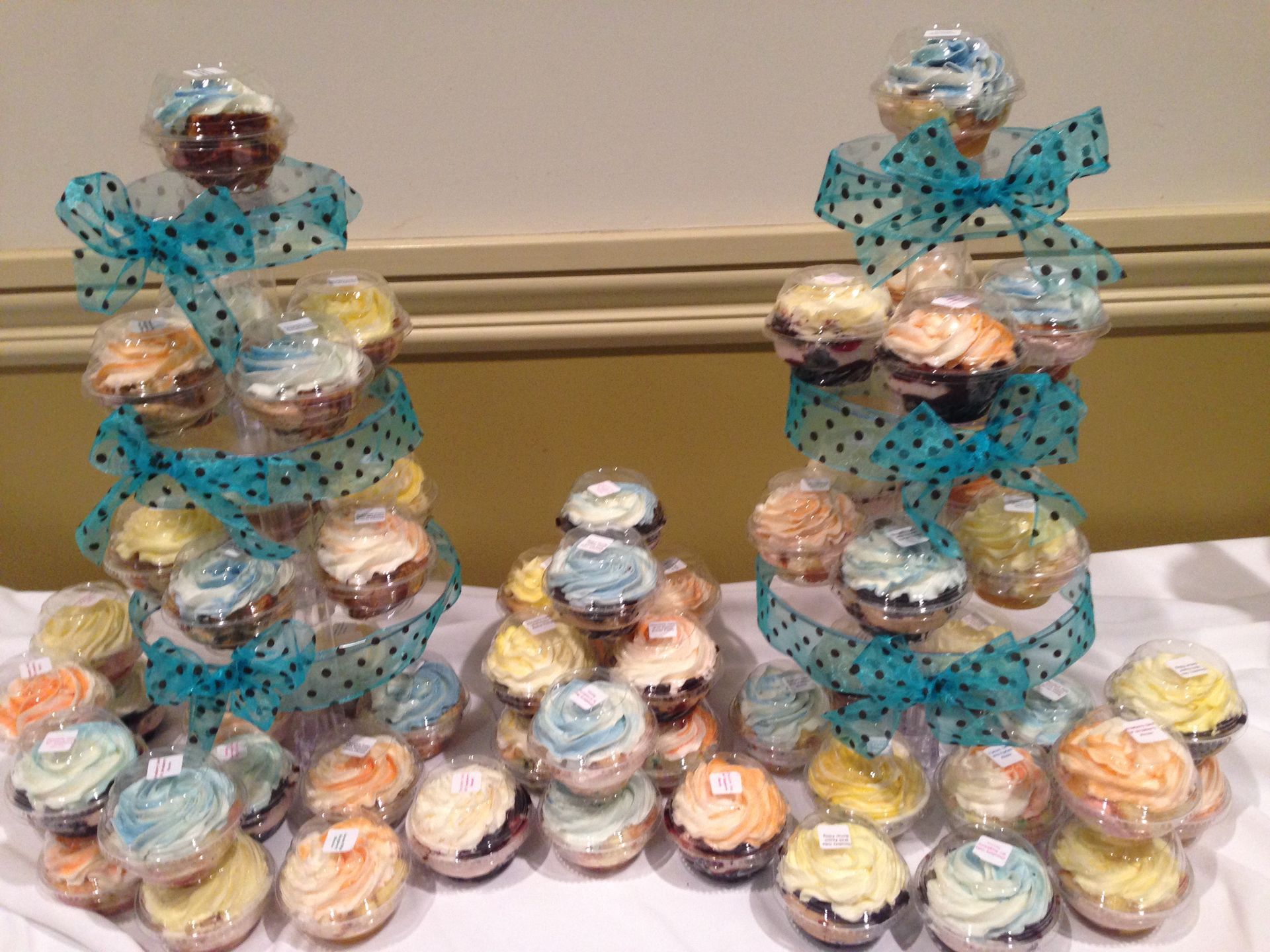 a bunch of cupcakes are on display on a table