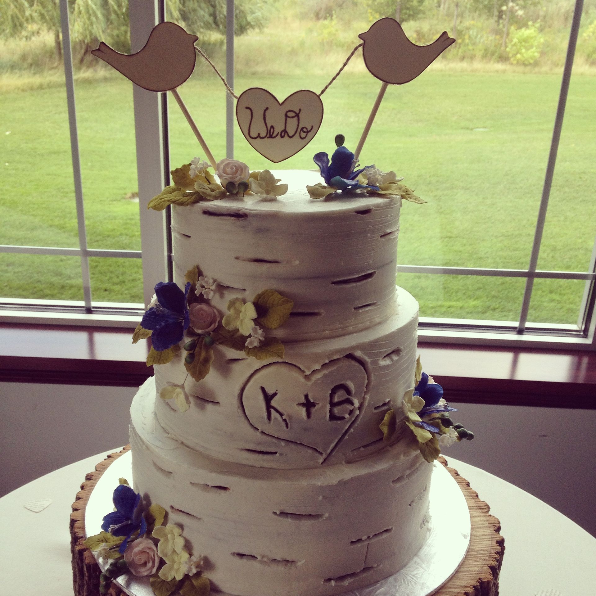 a three tiered wedding cake with a topper that says we do
