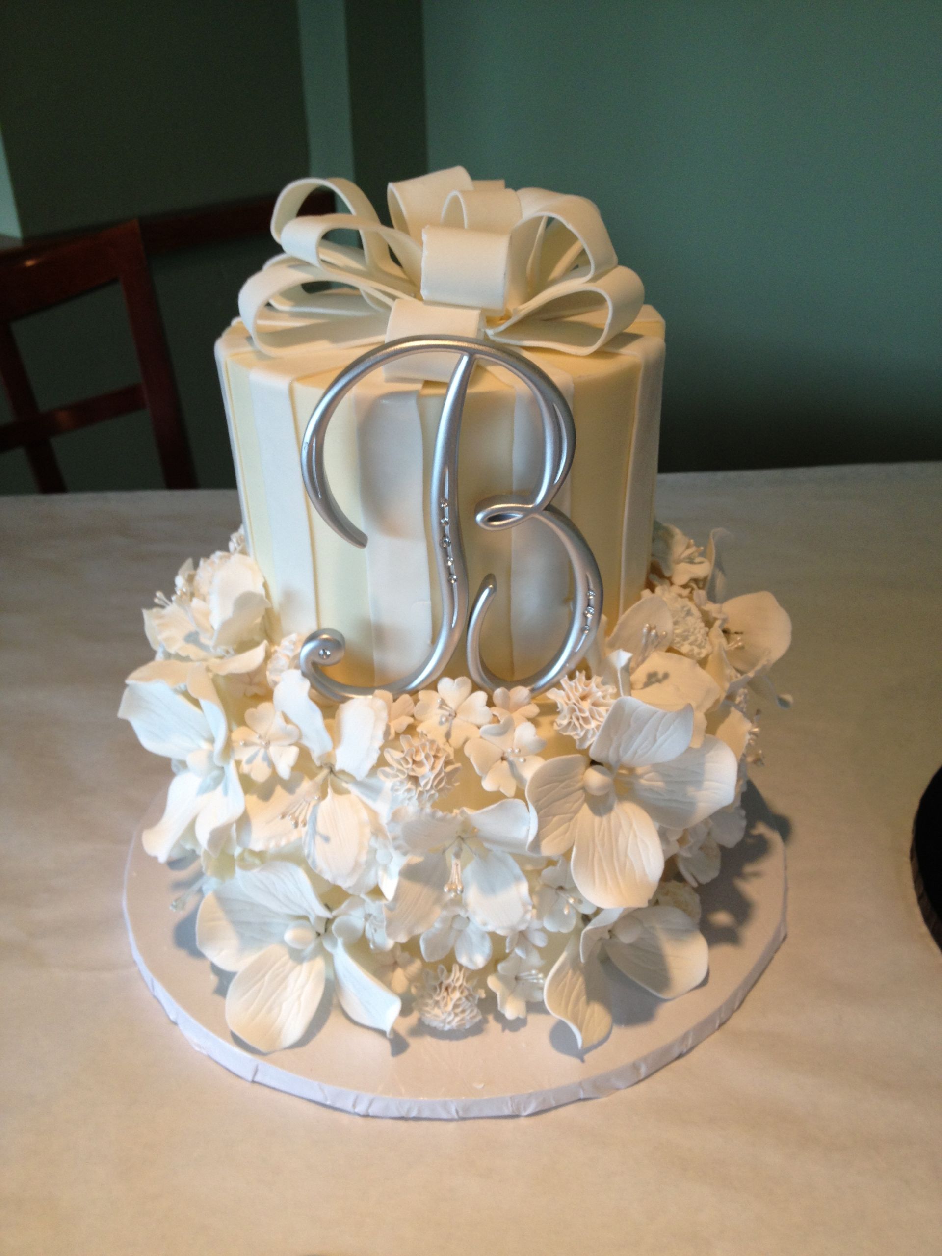 a white cake with the letter b on it