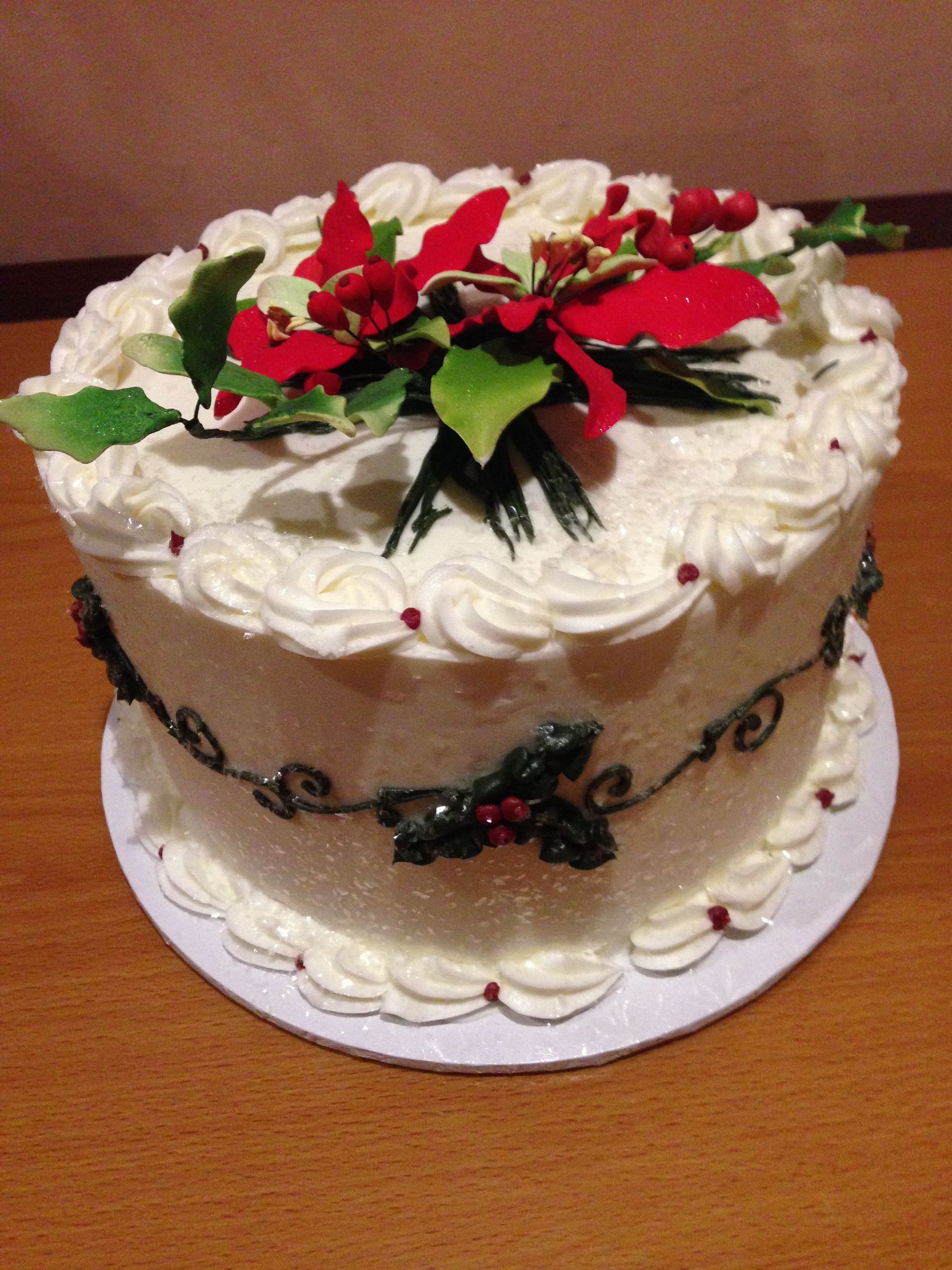 a christmas cake with a poinsettia on top