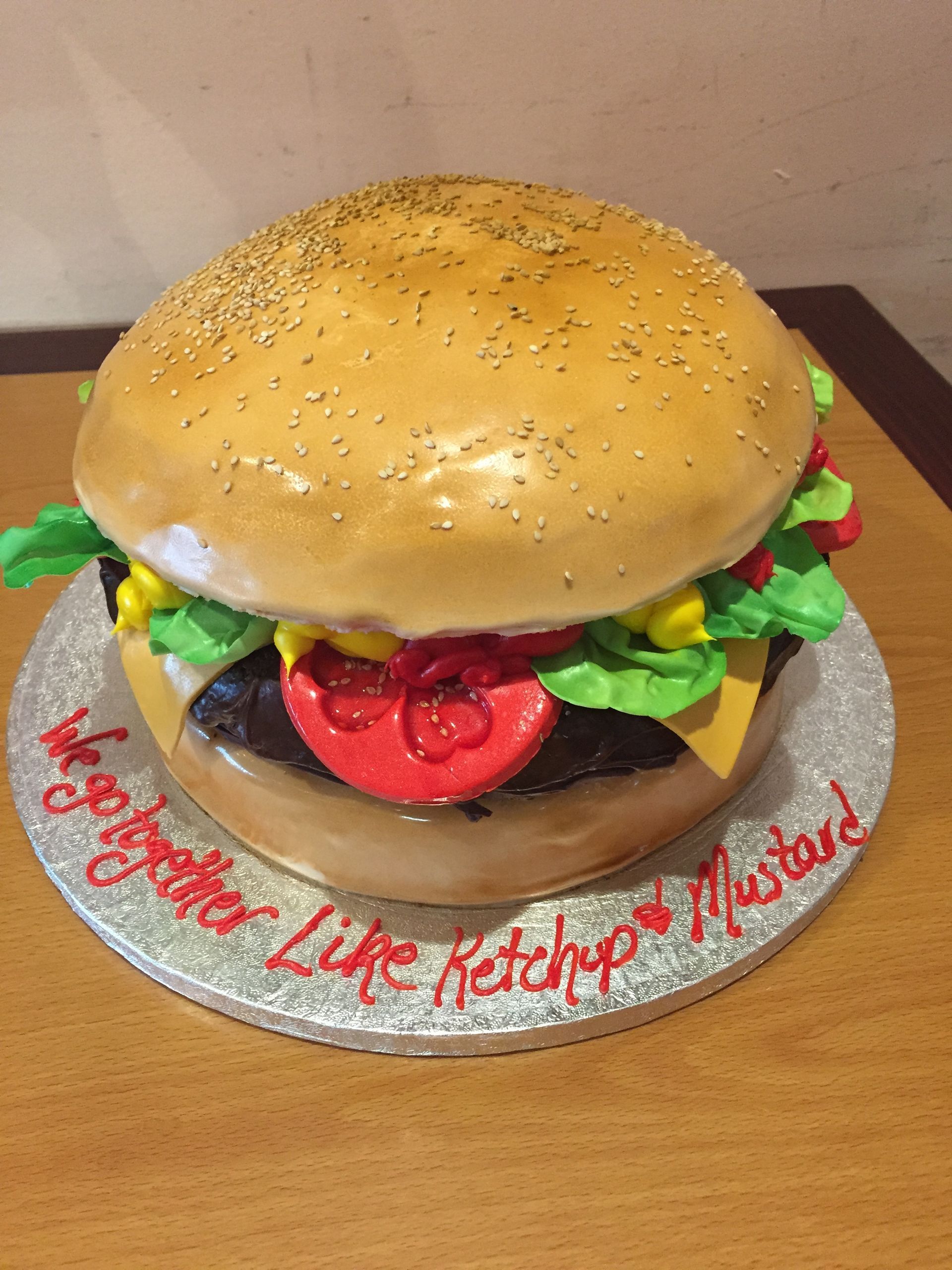 a cake that looks like a hamburger with ketchup on it