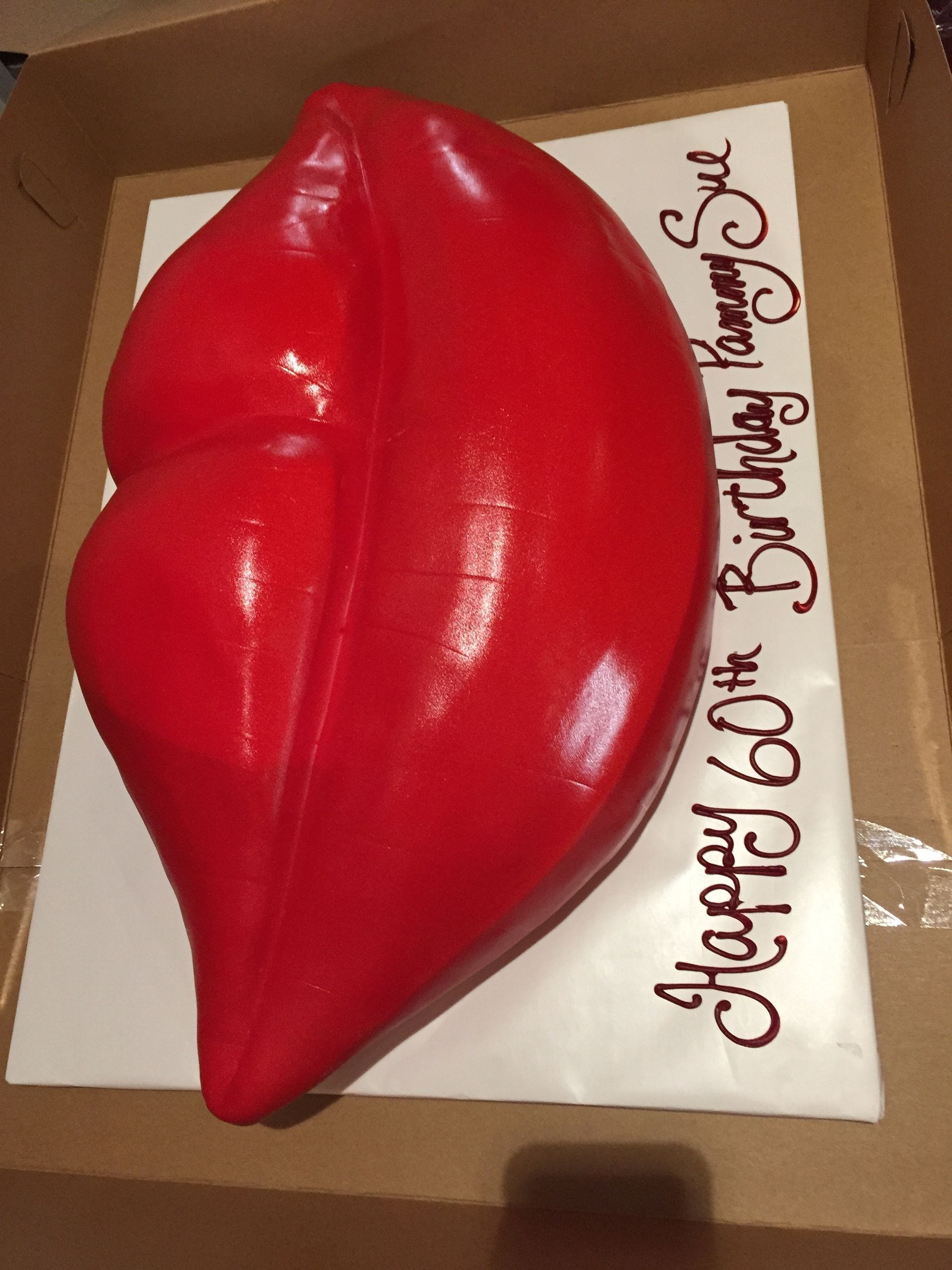 a cake in the shape of a red lip says happy 60th birthday sue