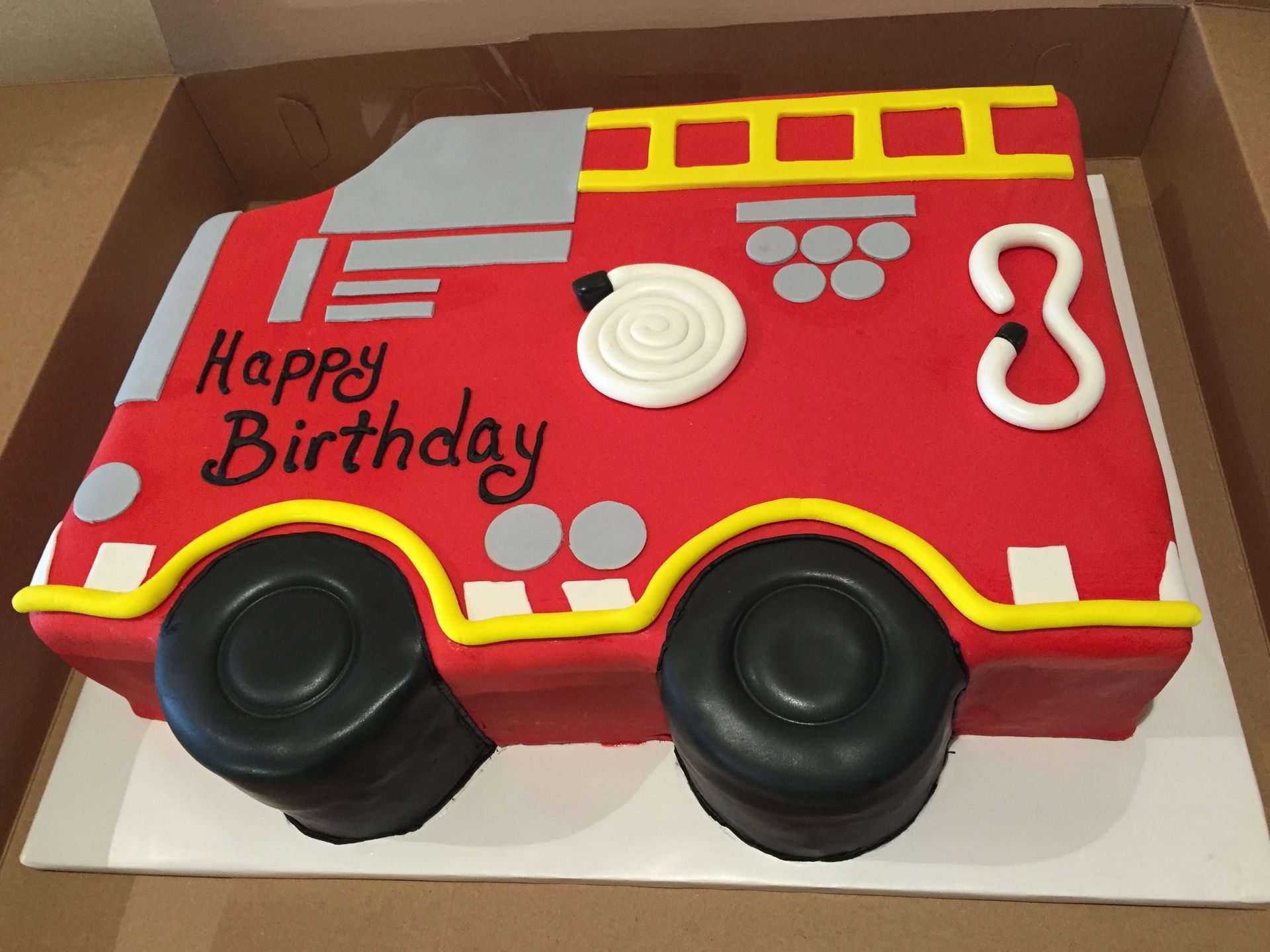 a birthday cake in the shape of a fire truck