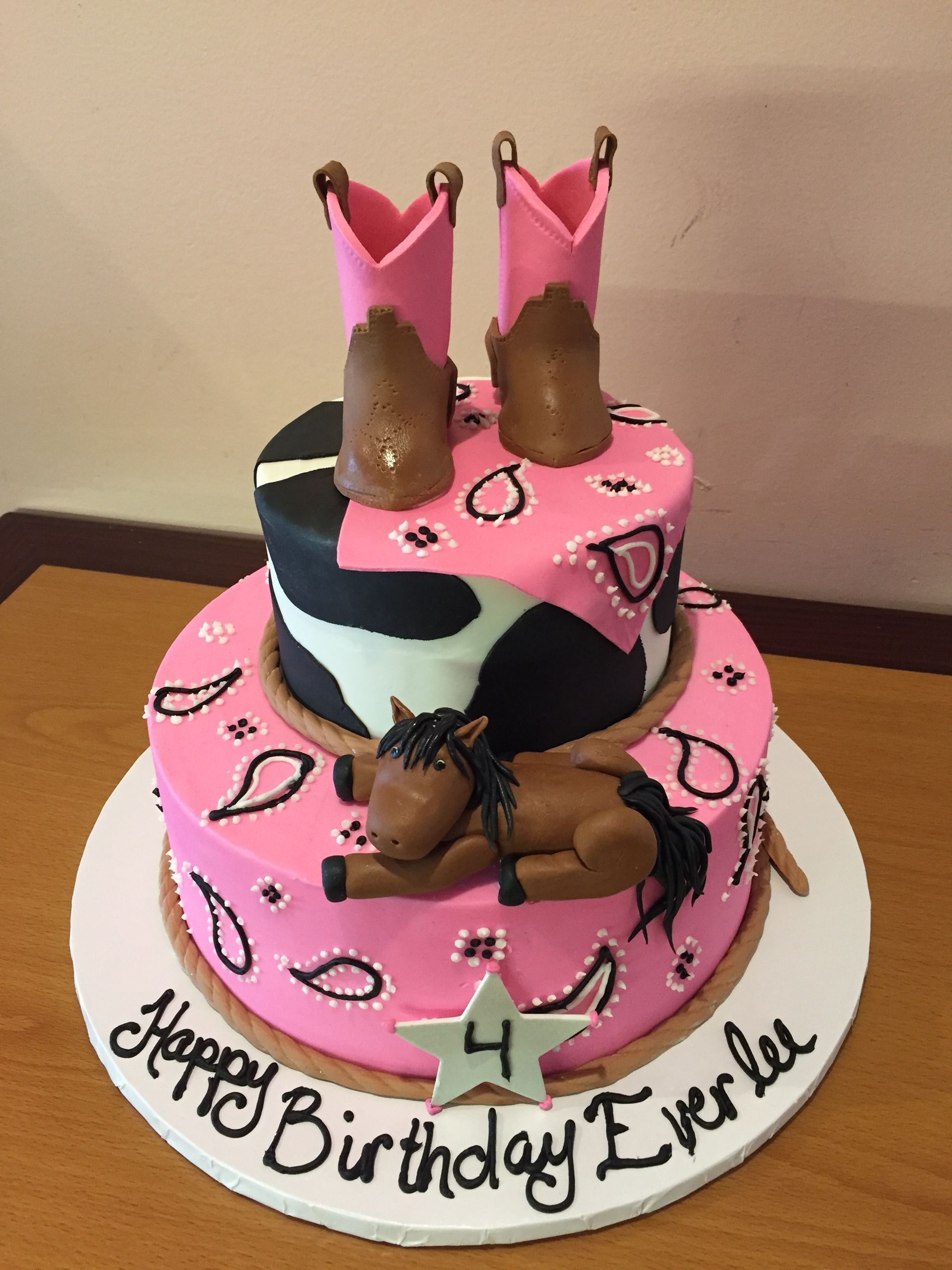 a birthday cake with a horse and cowboy boots on it