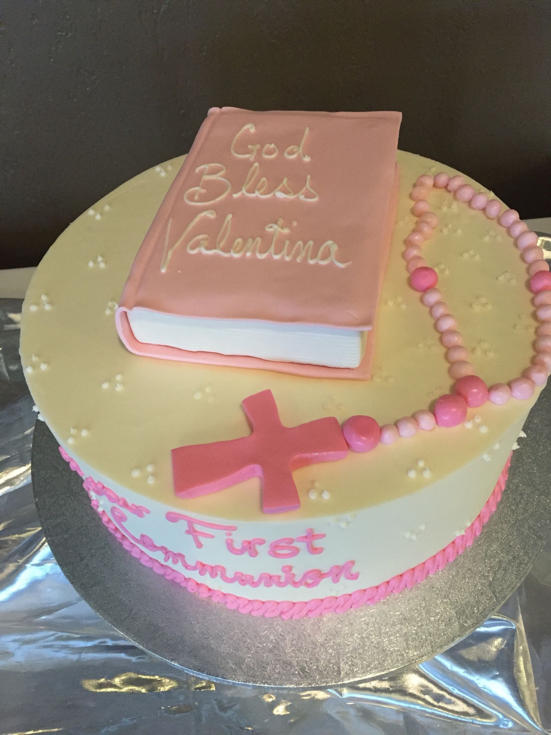 a cake with a rosary and a bible on it