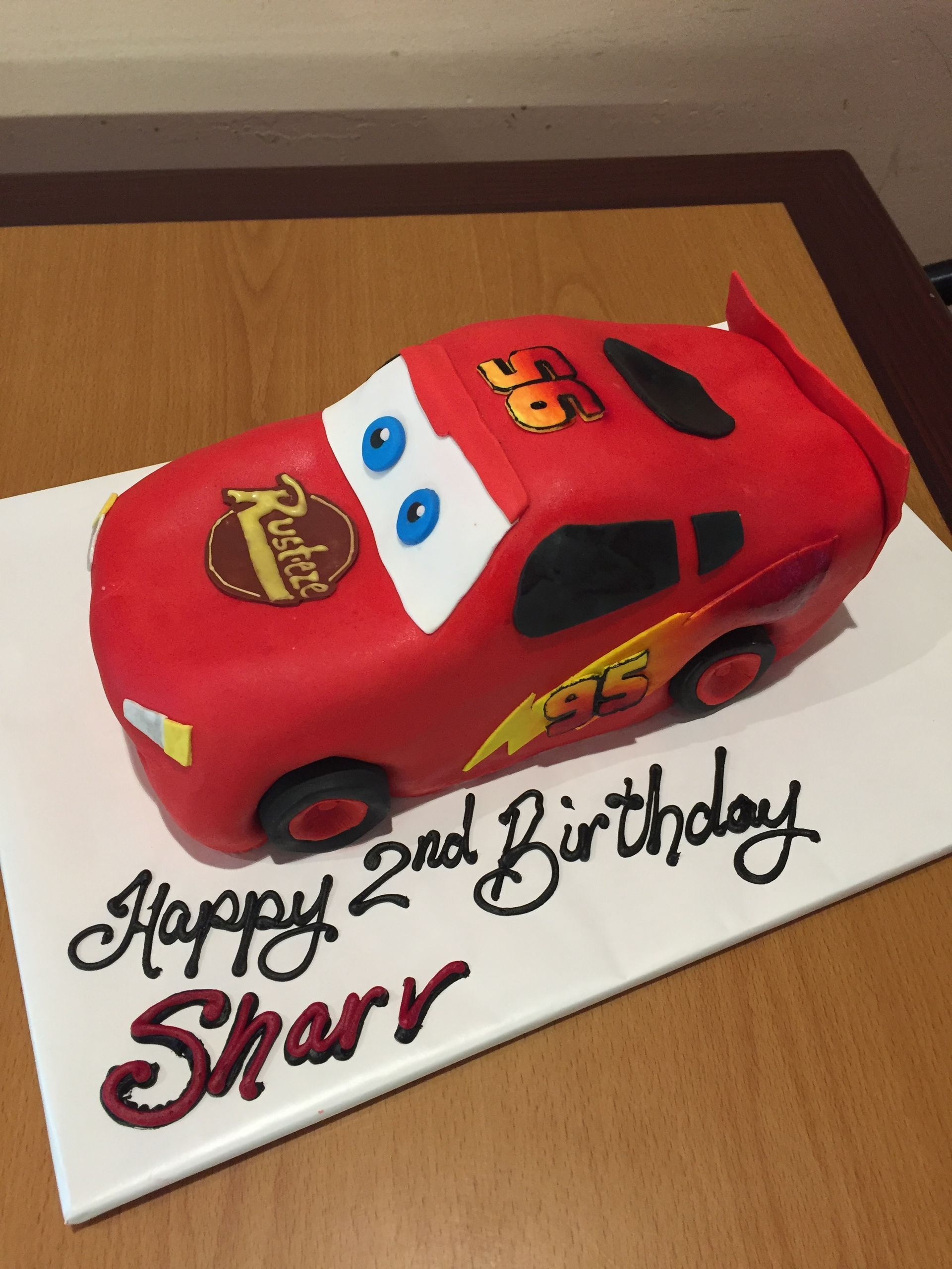 a birthday cake with a lightning mcqueen car on it