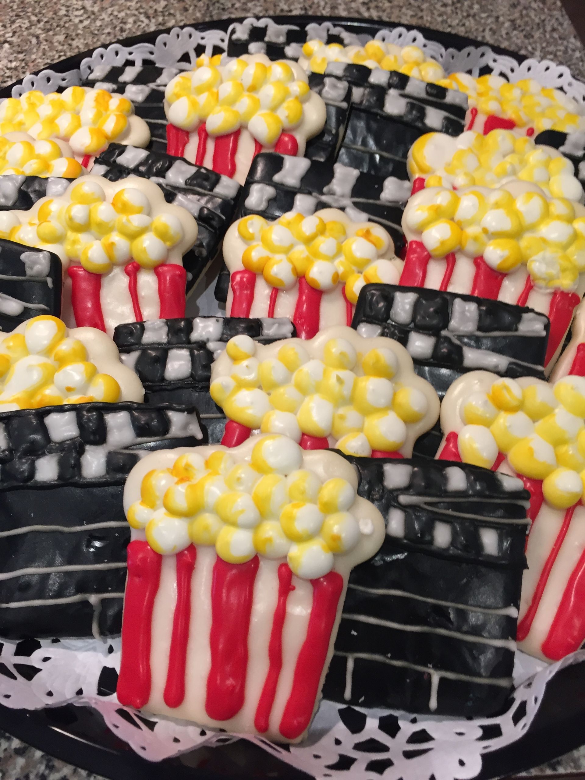 a tray of cookies decorated to look like buckets of popcorn