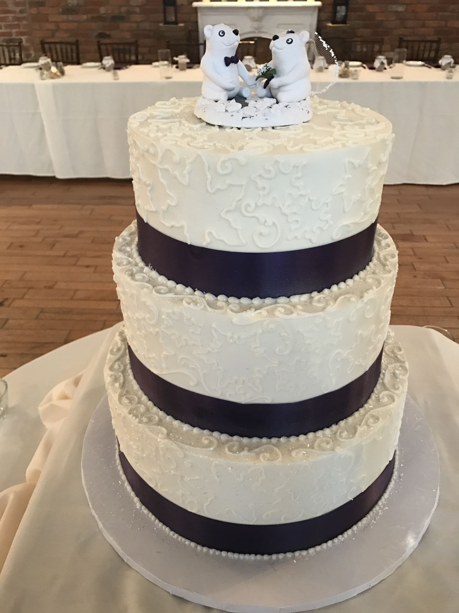 a wedding cake with two polar bears on top of it