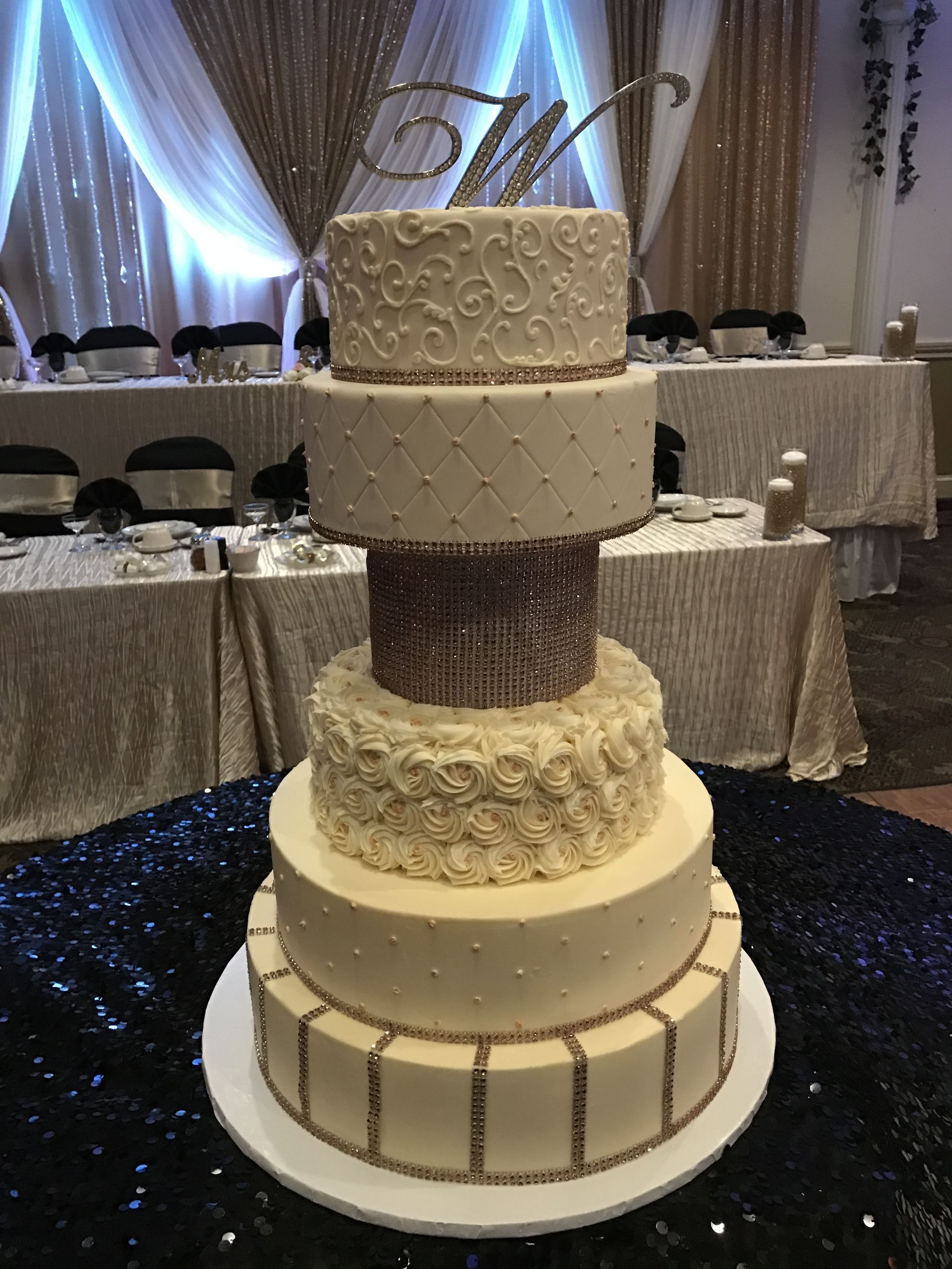 a wedding cake is sitting on a table in a room .