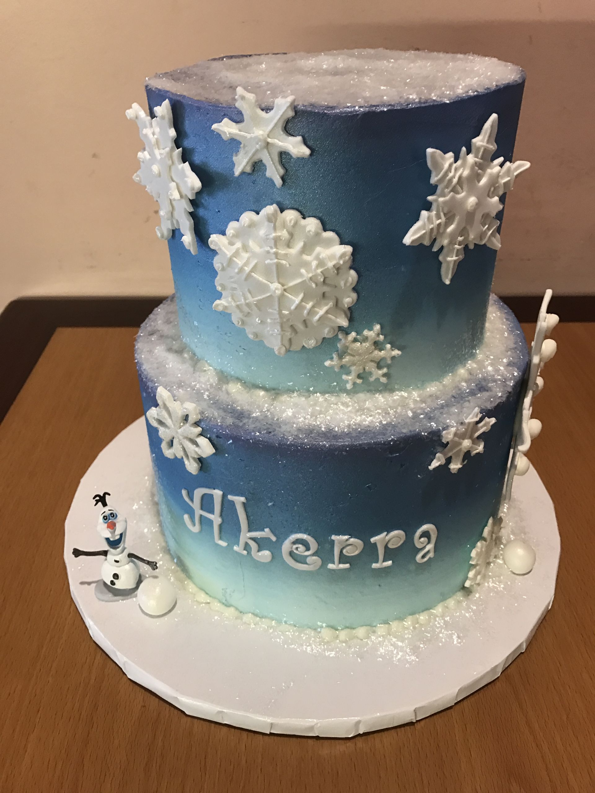 a cake with snowflakes and the name akerra on it