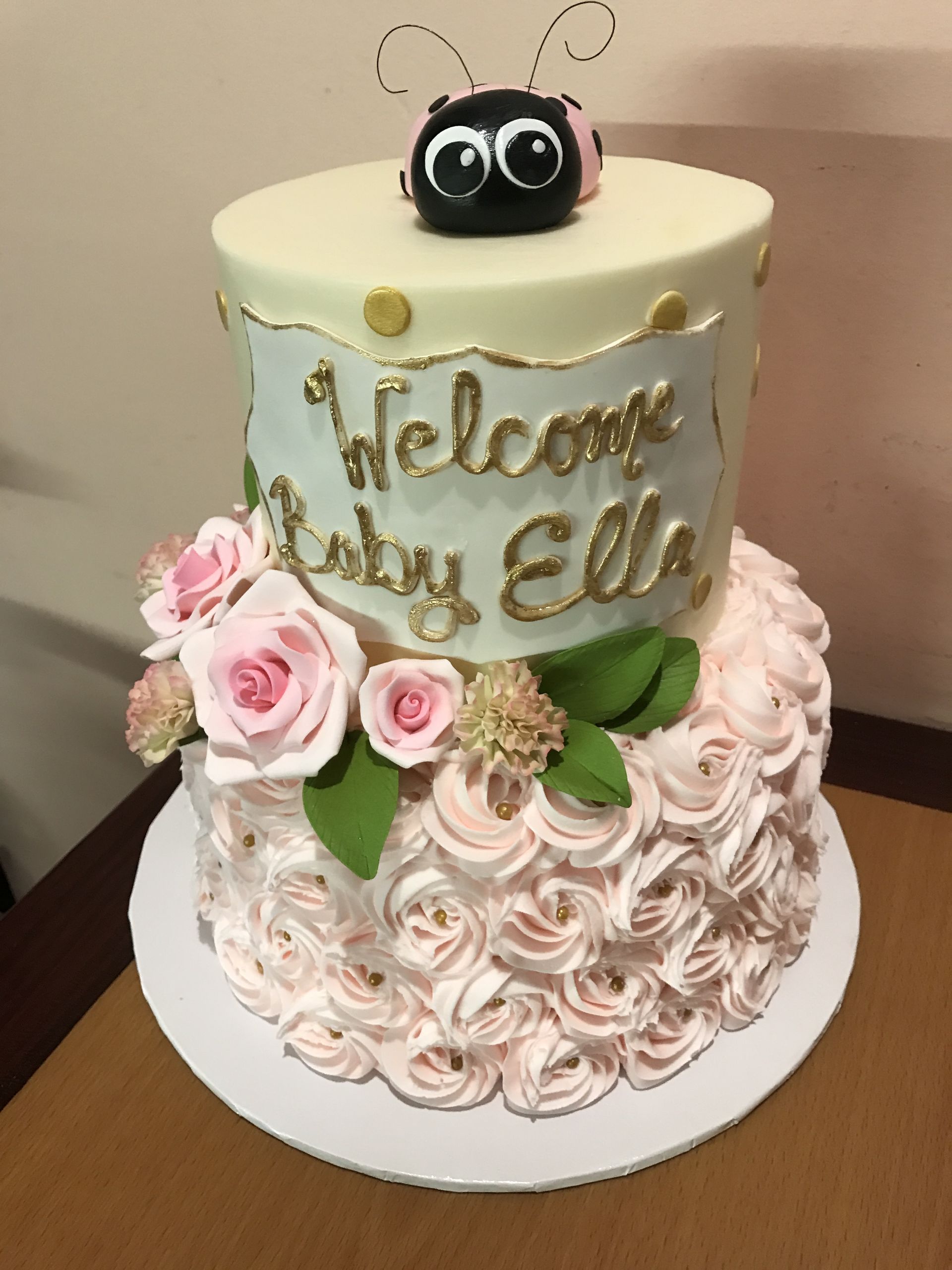 a cake that says welcome baby ella on it