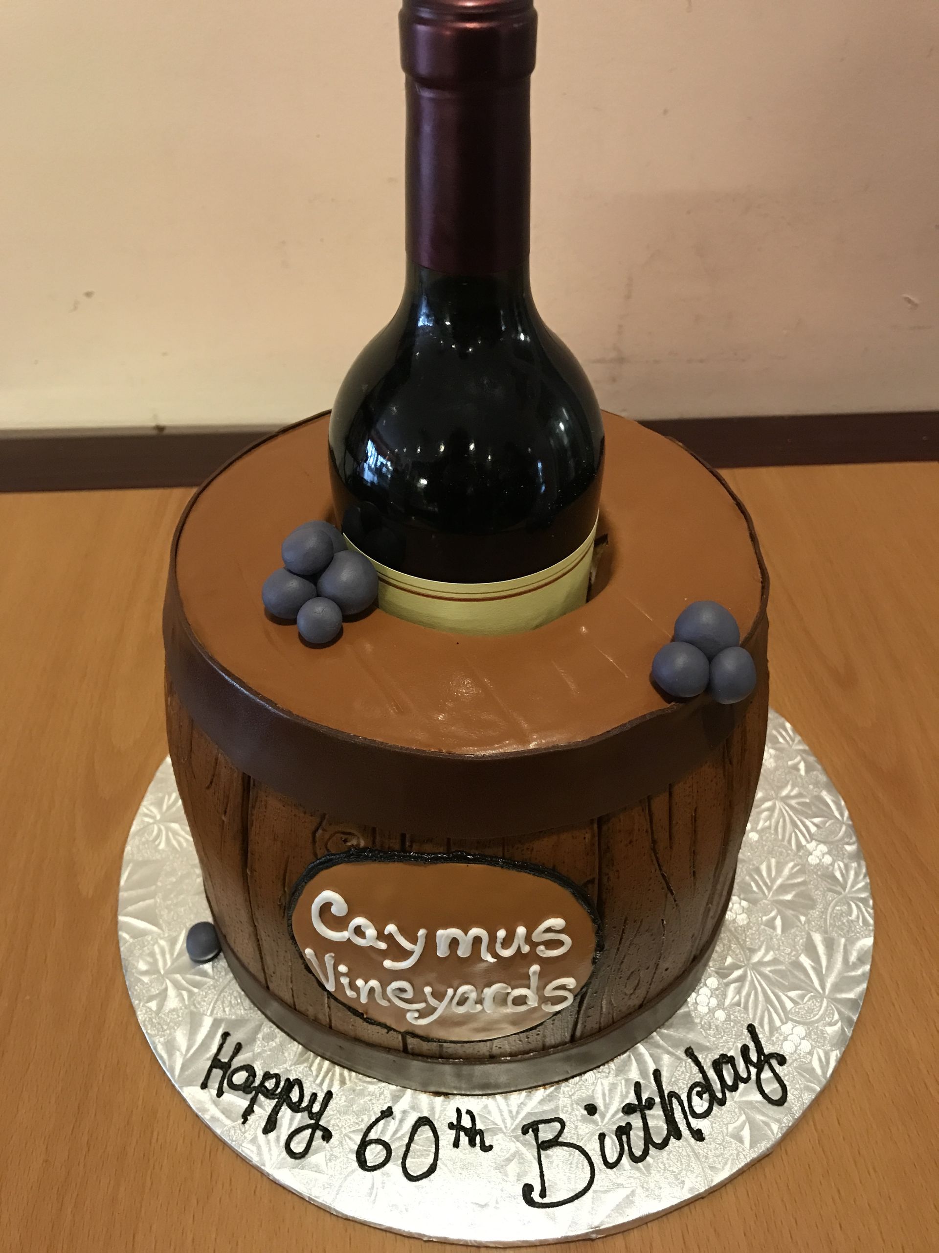 a birthday cake with a bottle of wine on top