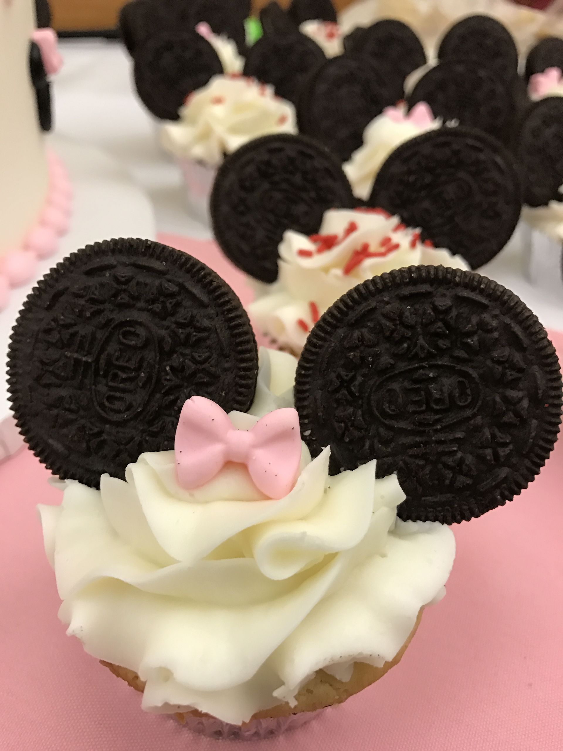 a cupcake with oreos in the shape of mickey mouse ears