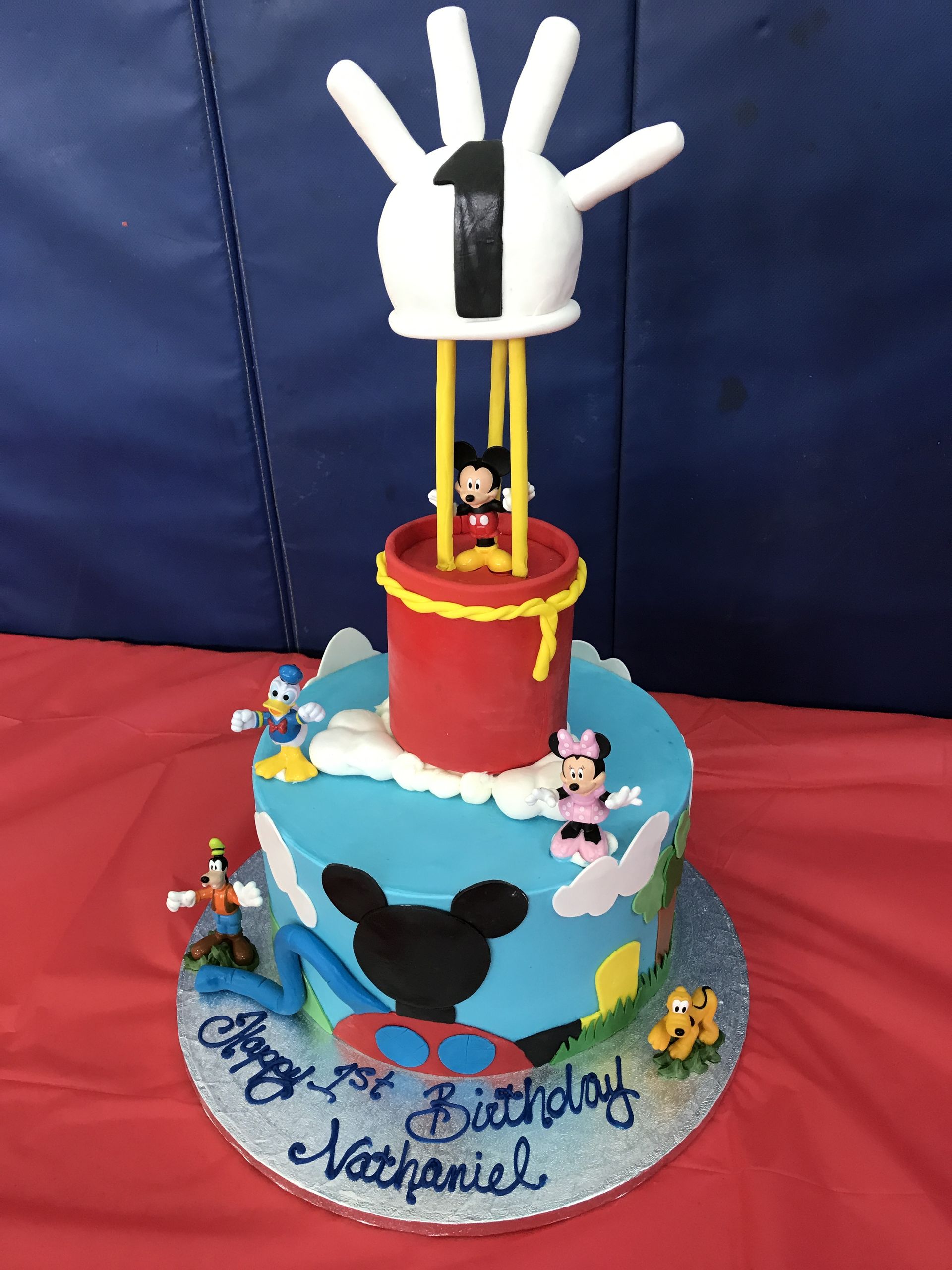 a birthday cake with mickey mouse and minnie mouse on it