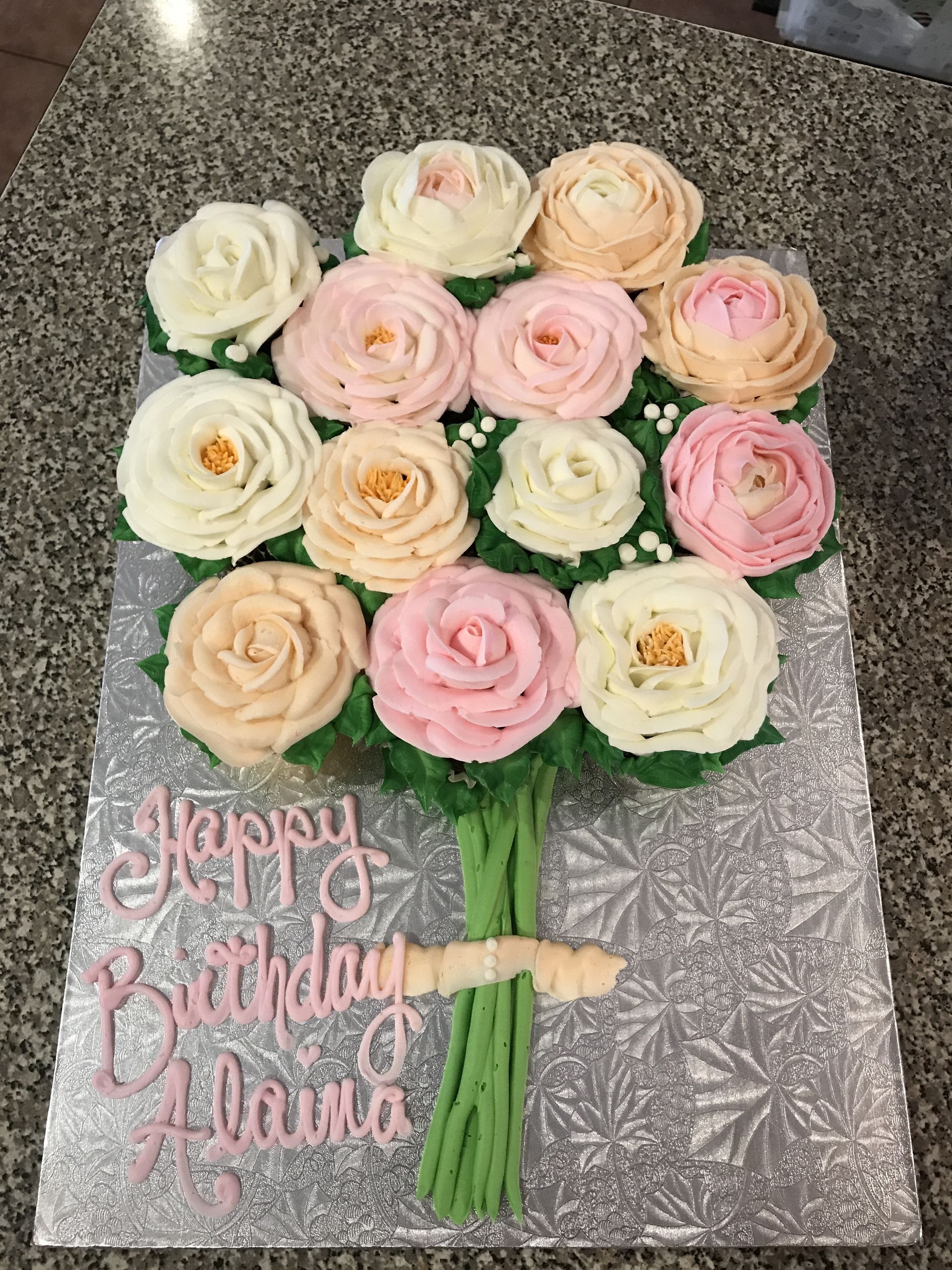 a bunch of cupcakes decorated to look like a bouquet of roses .