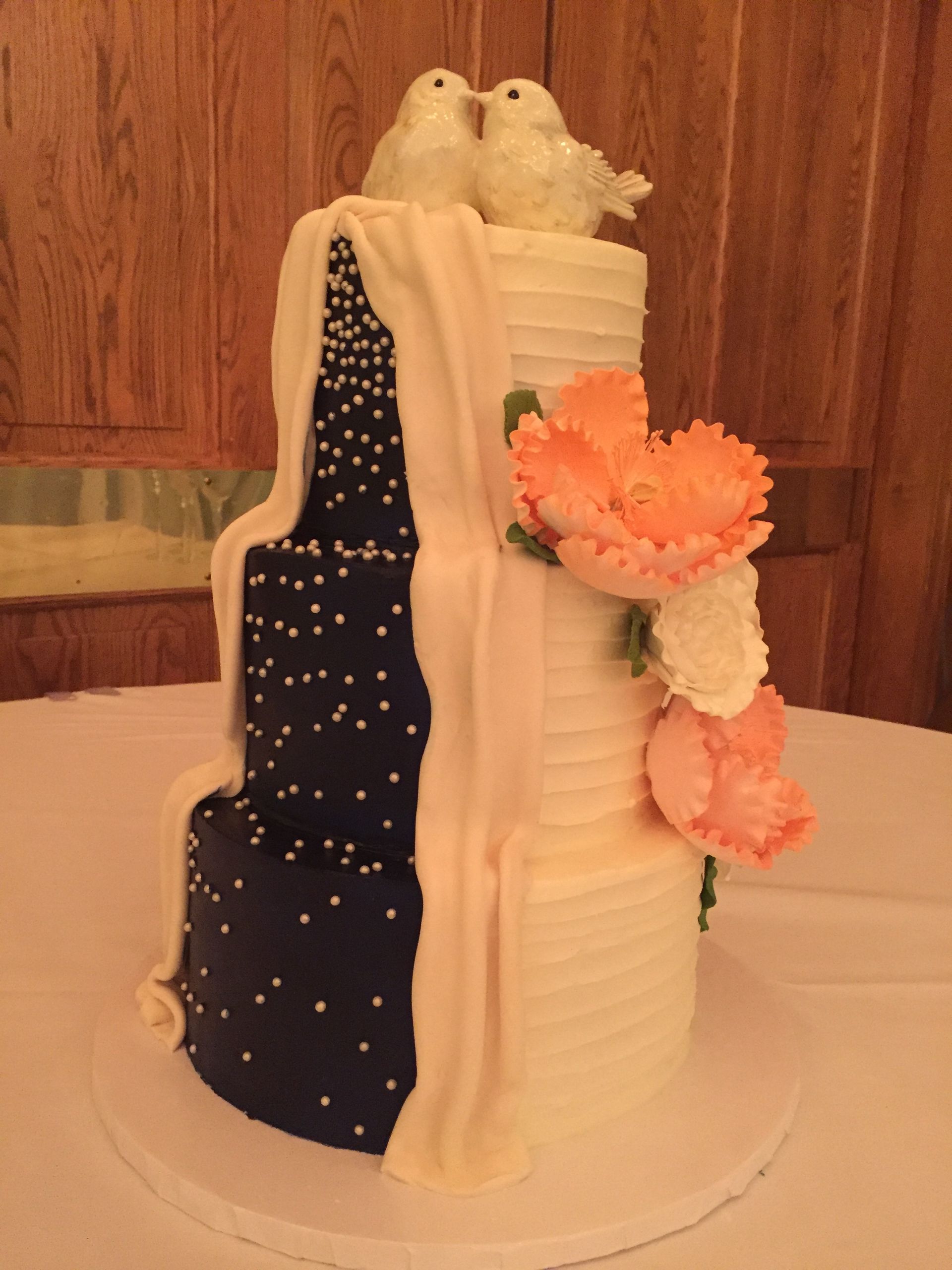 a wedding cake with two birds on top of it