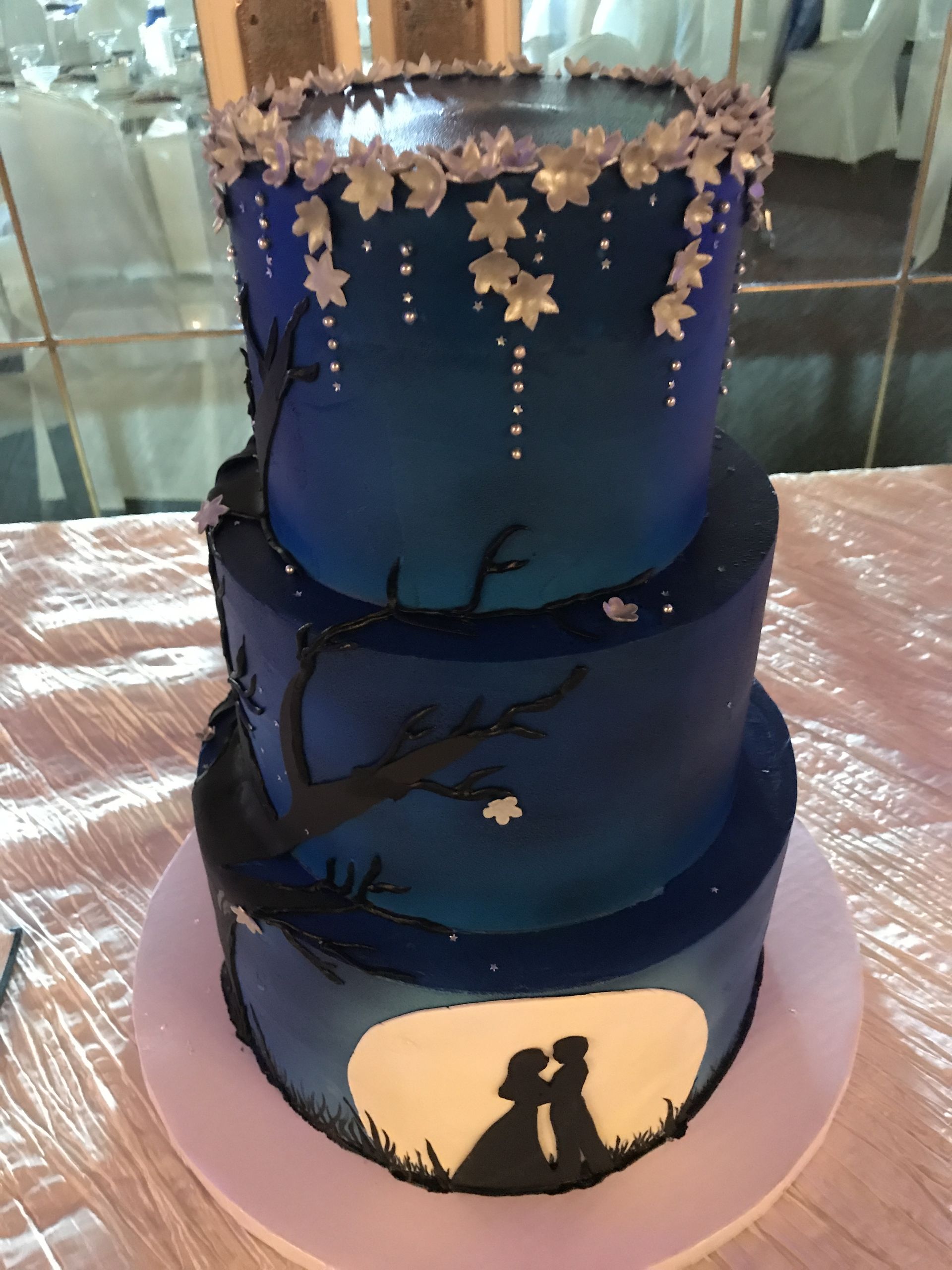 a wedding cake with a couple kissing on it