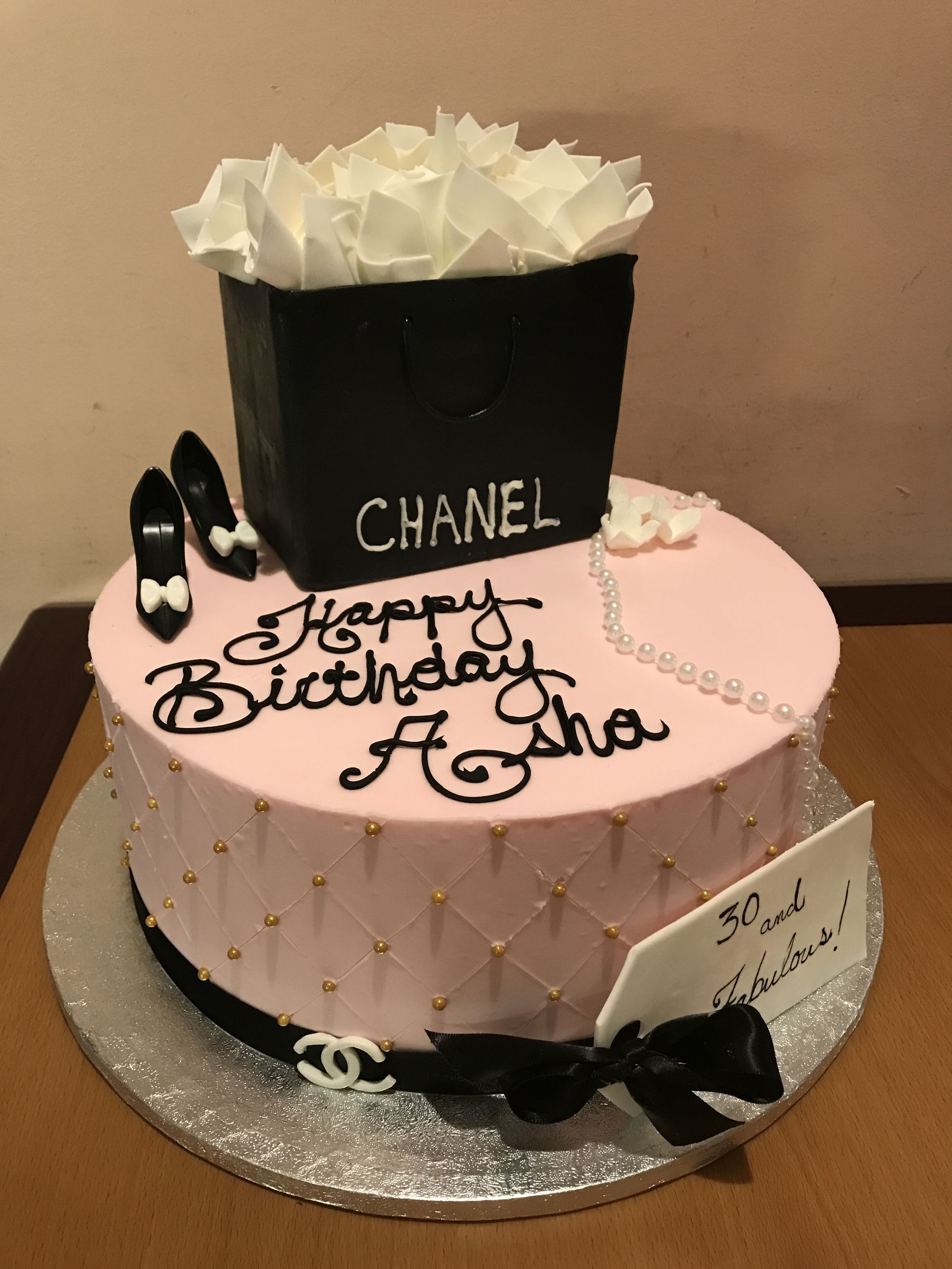 a birthday cake with a chanel box on top