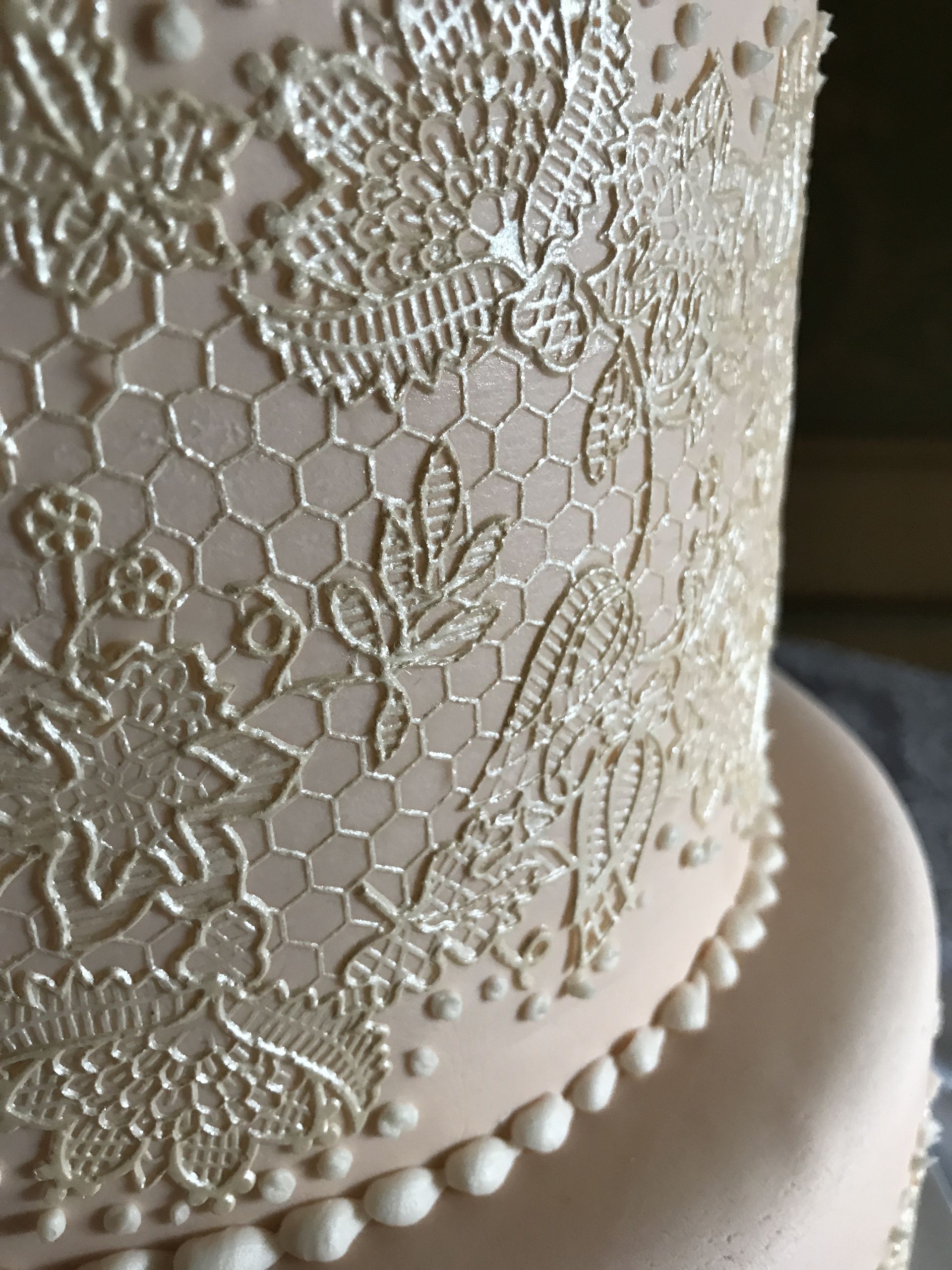 a close up of a cake with lace on it