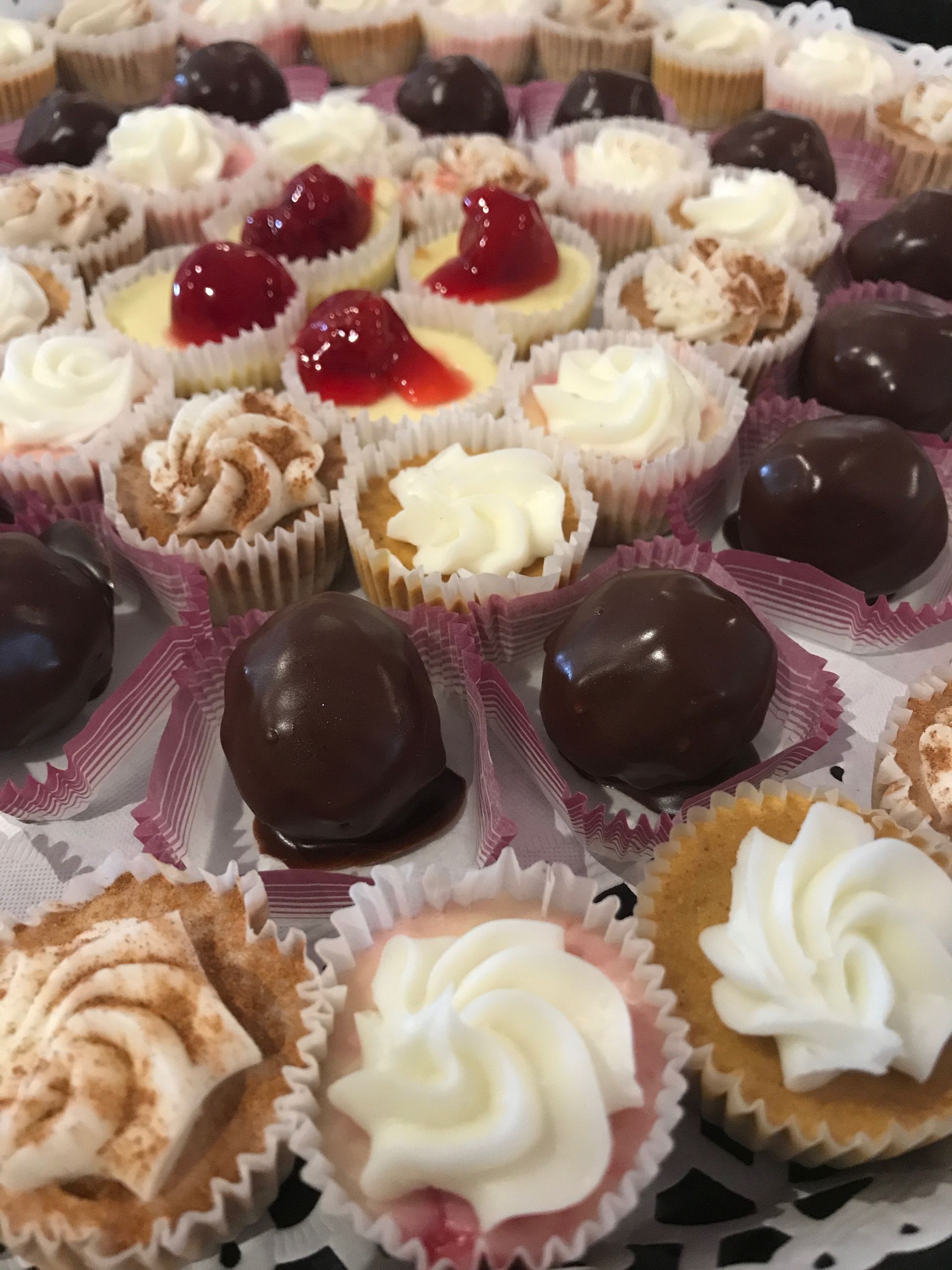 a bunch of cupcakes with different toppings on them