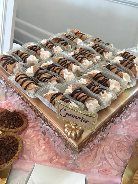 a tray of cannoli sitting on top of a table .