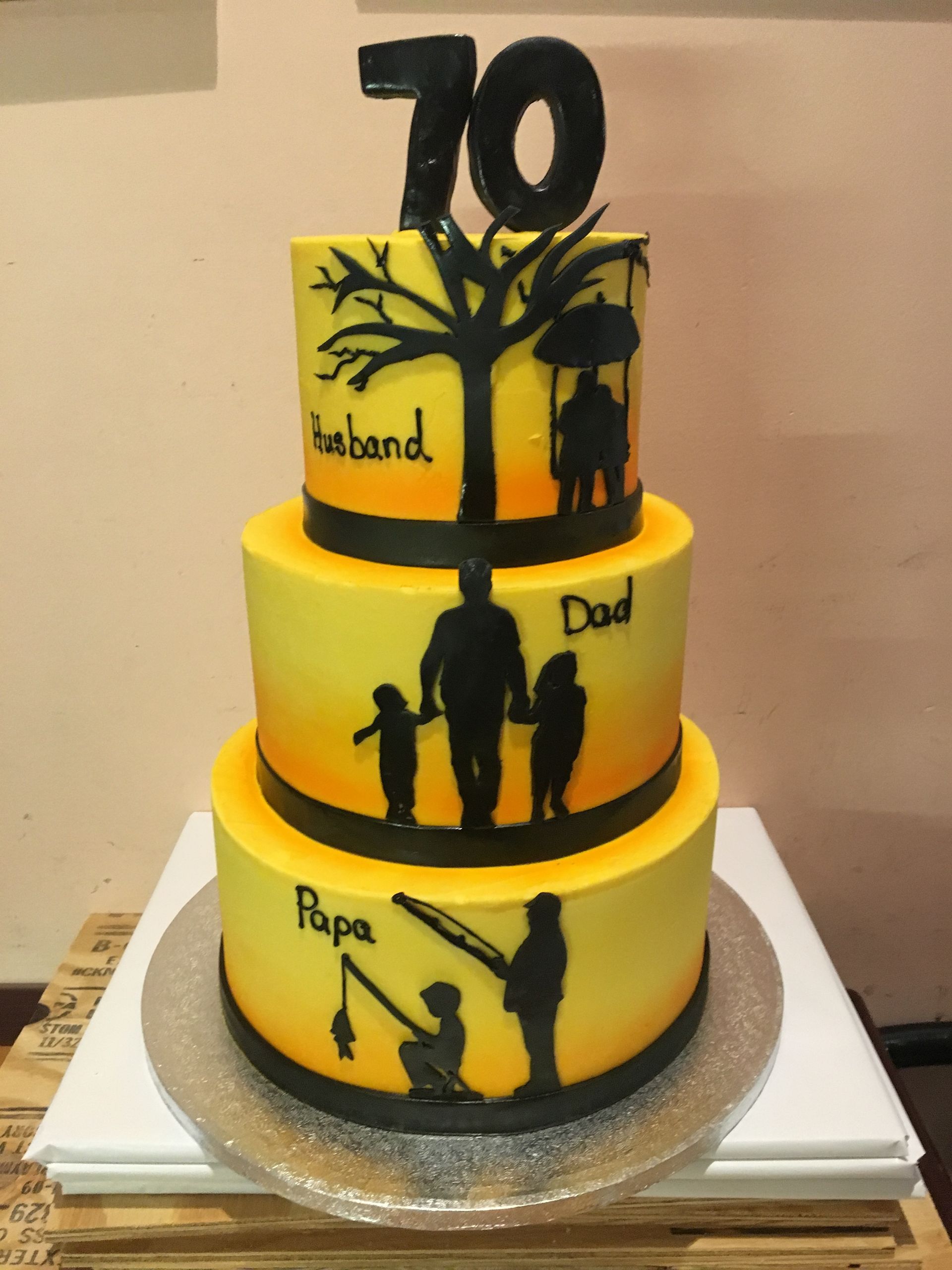 a yellow and black cake with the number 70 on top