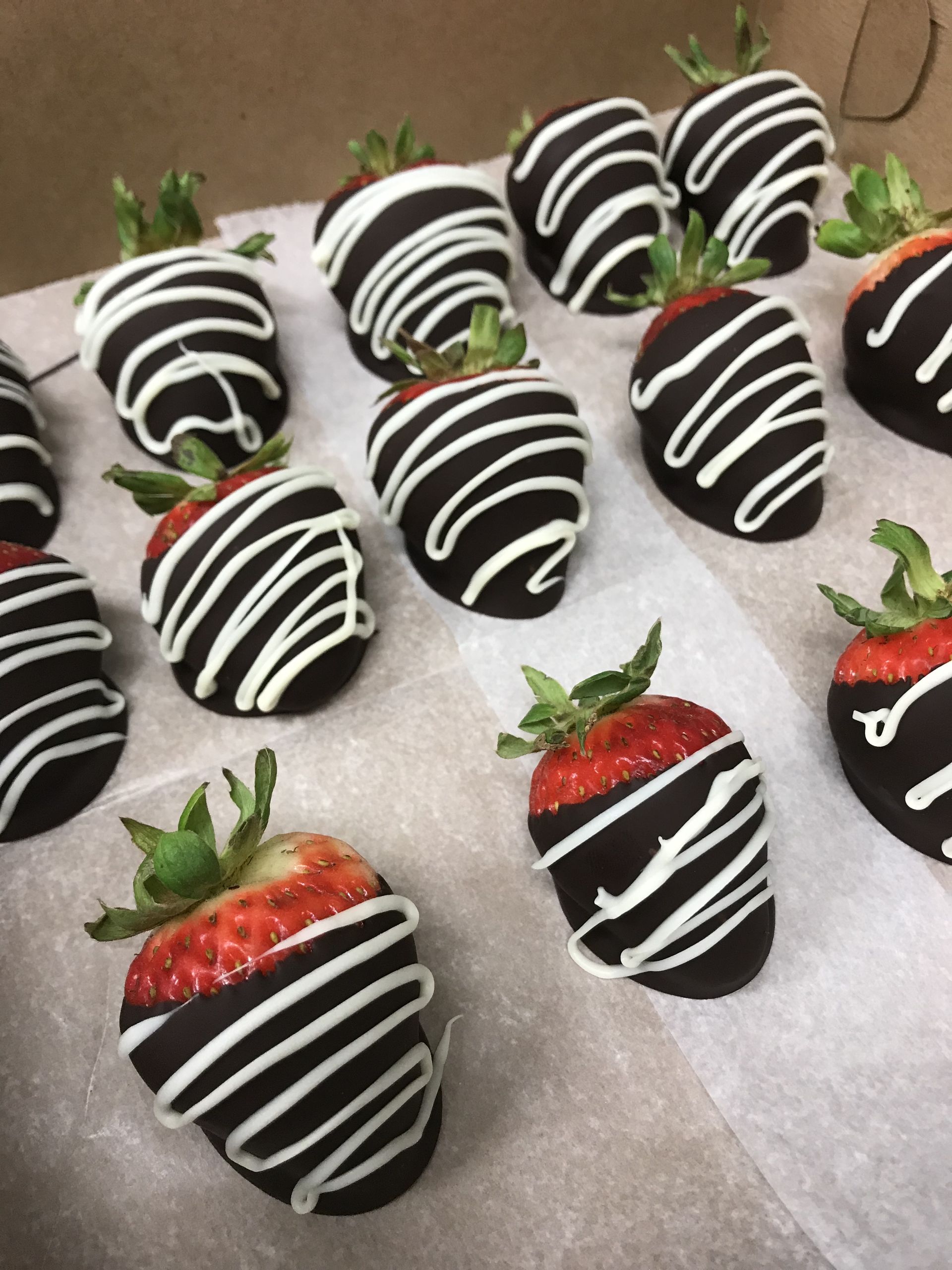 a bunch of chocolate covered strawberries on a table