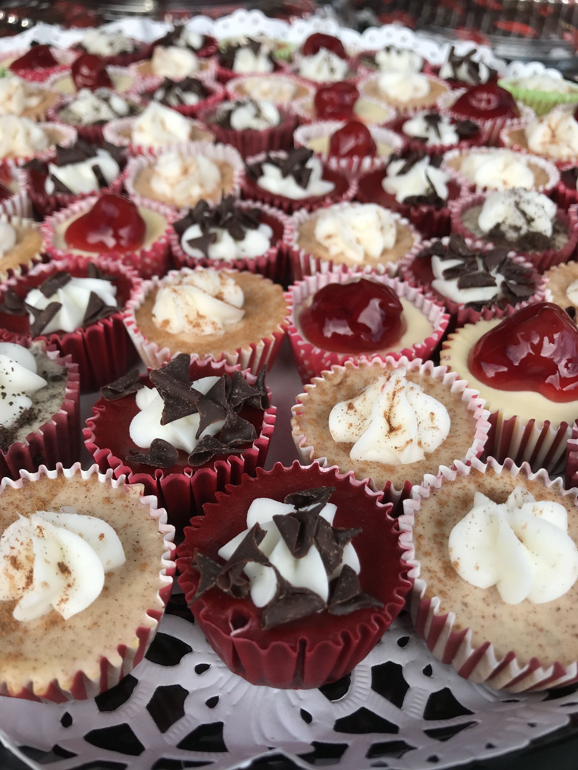 a tray of cupcakes with different toppings on them