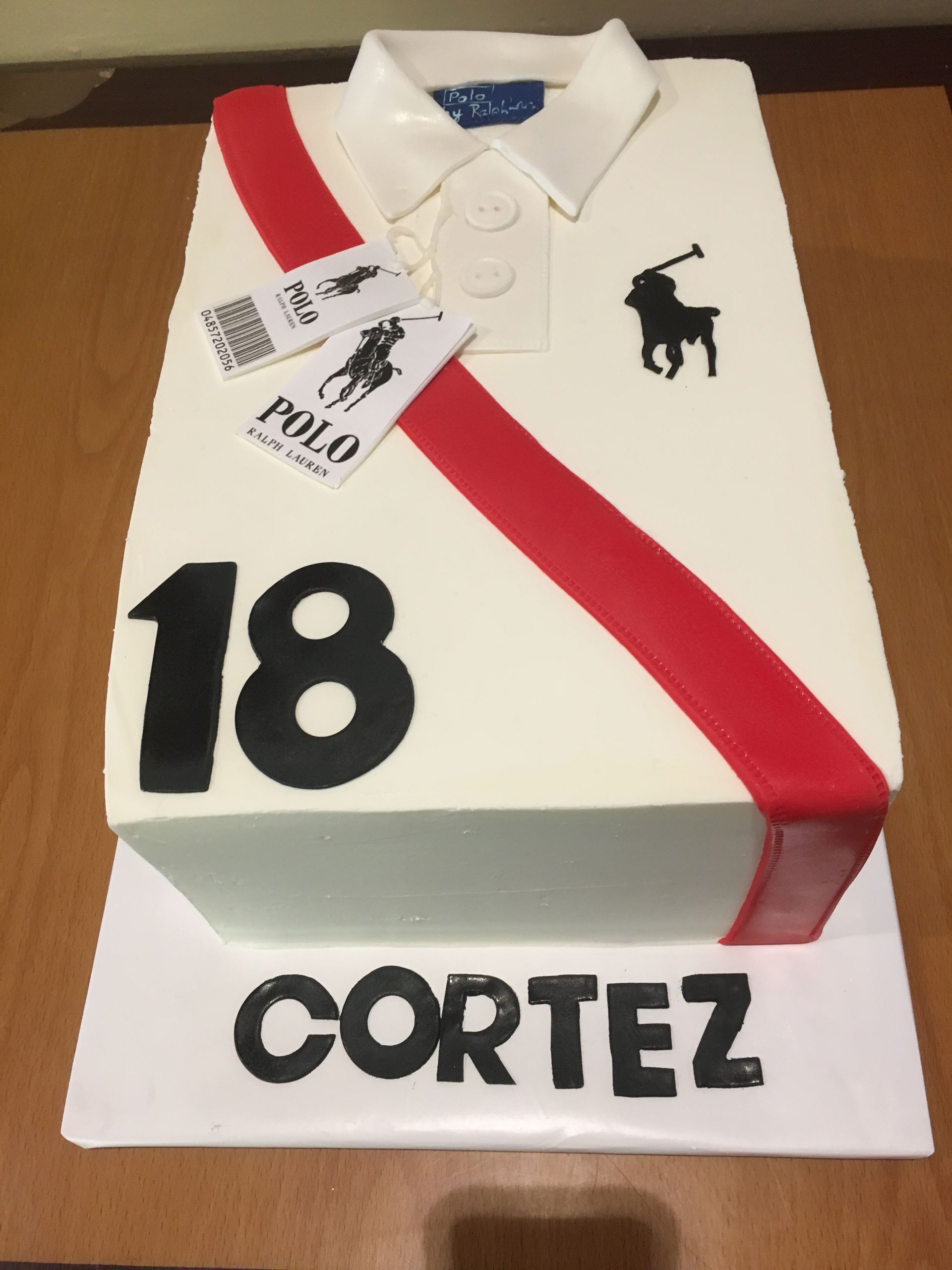 a cake that looks like a polo shirt with the number 18 on it