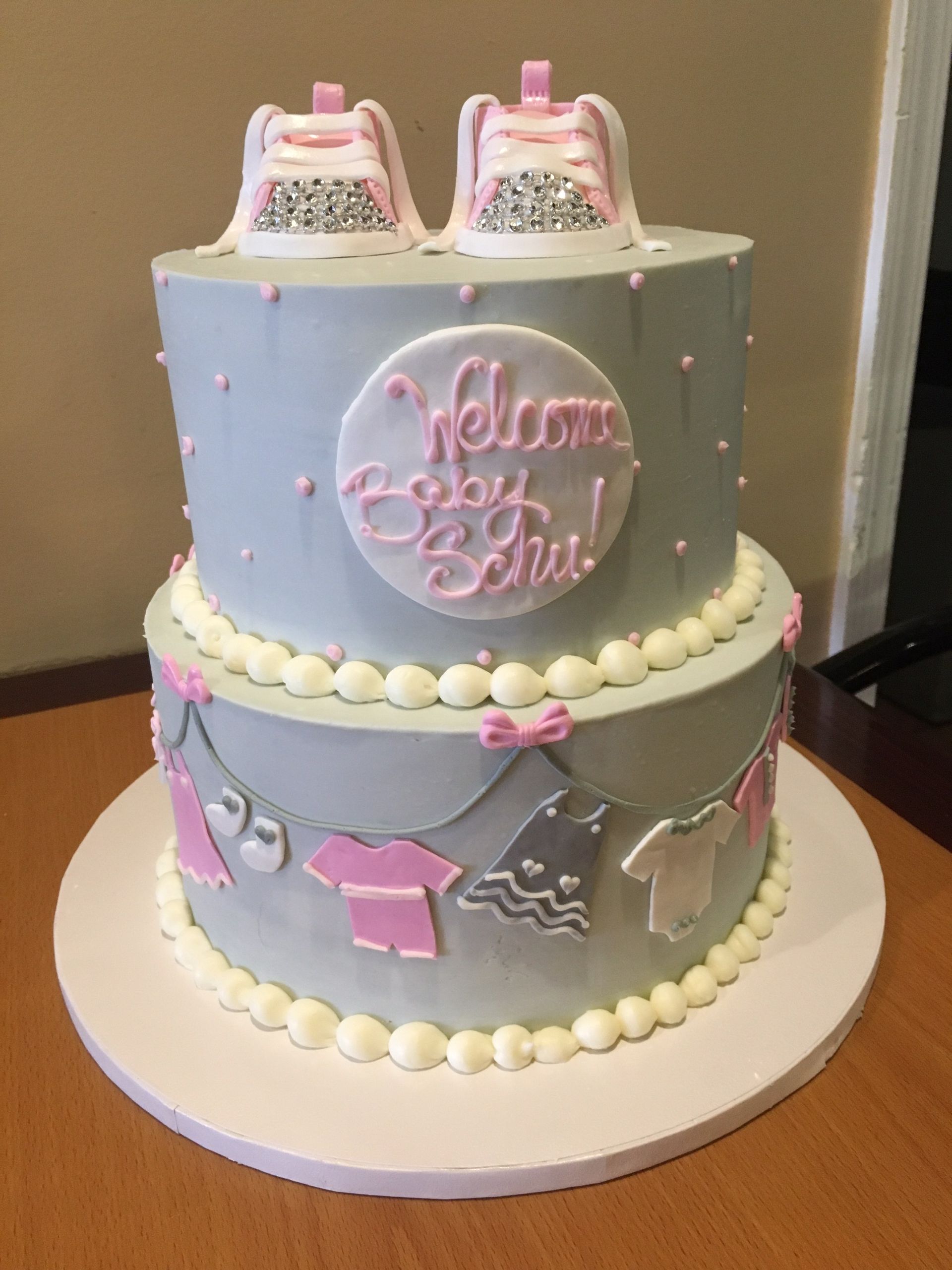 a cake that says welcome baby girl on it