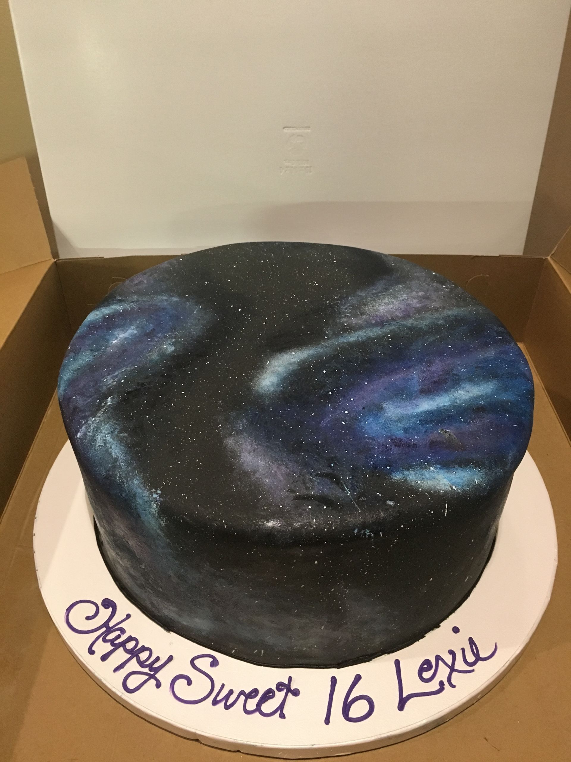 a birthday cake with a galaxy design on it