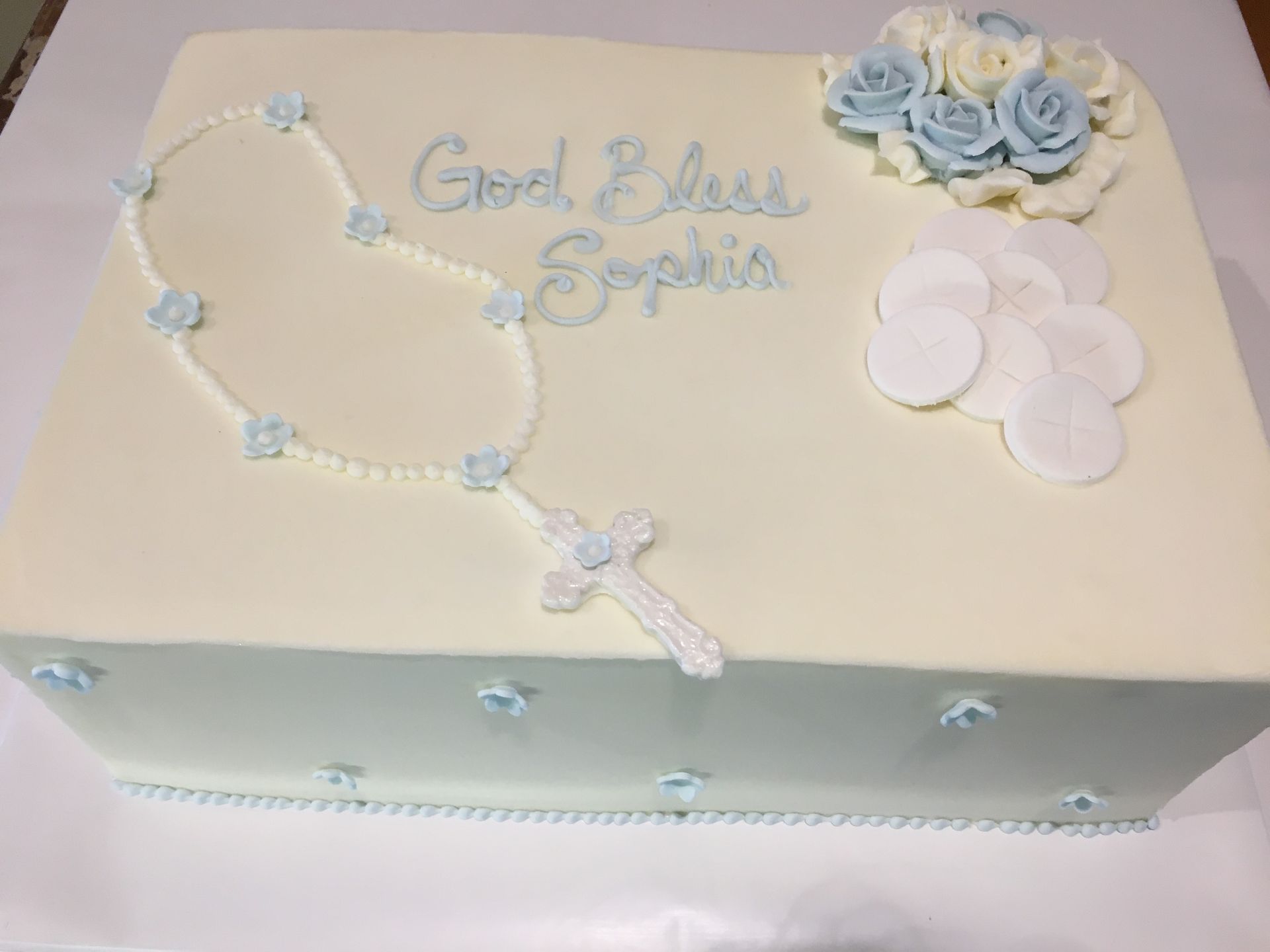 a cake with a rosary and a cross on it .