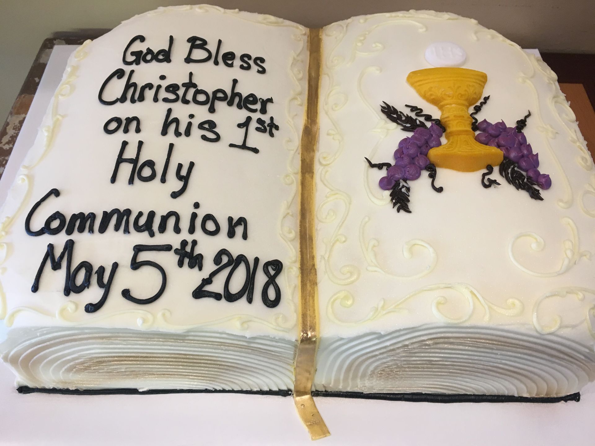 a cake that looks like a bible that says god bless christopher on his 1st holy communion may 5th 2018