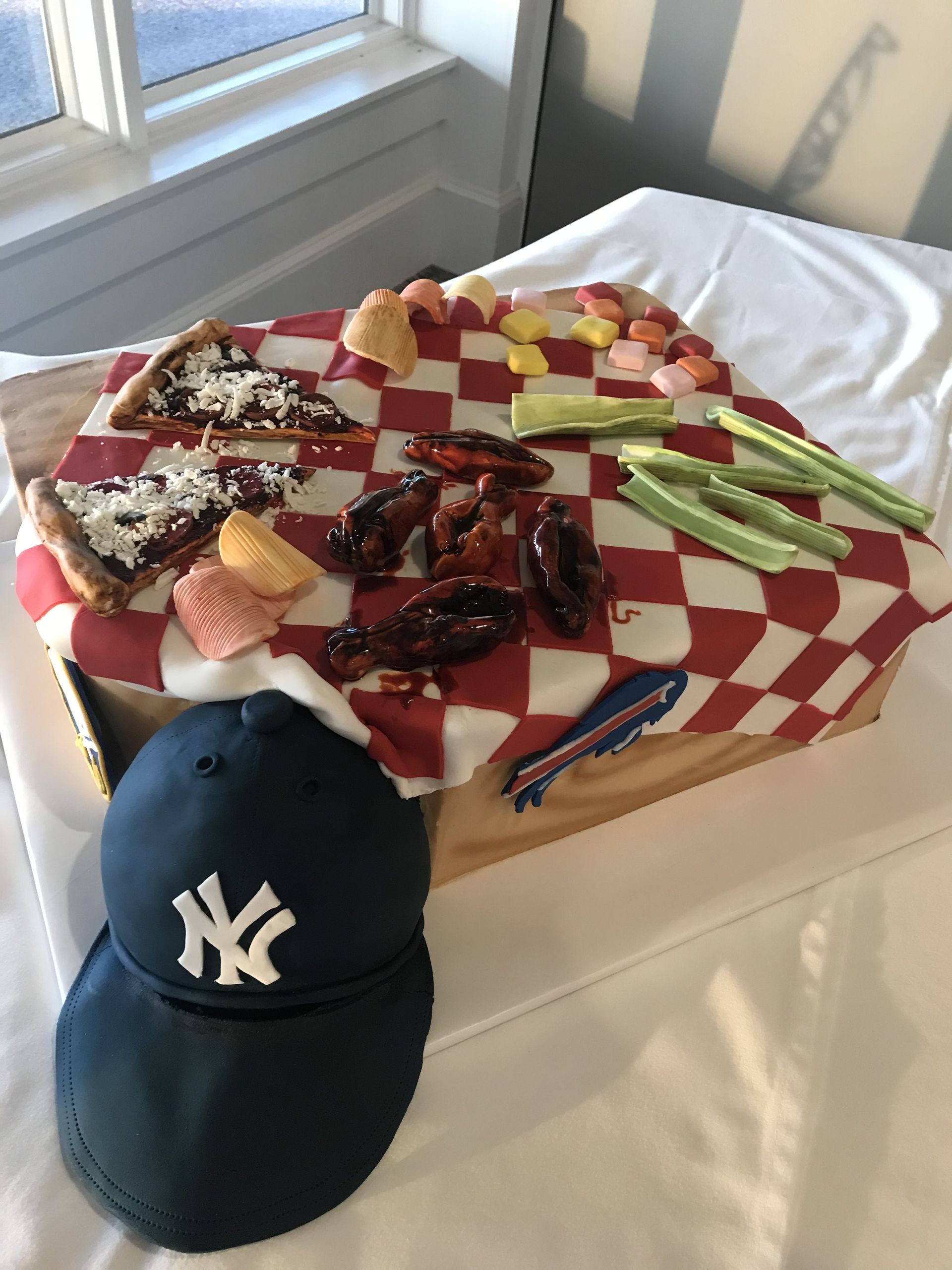 a ny hat sits next to a tray of food