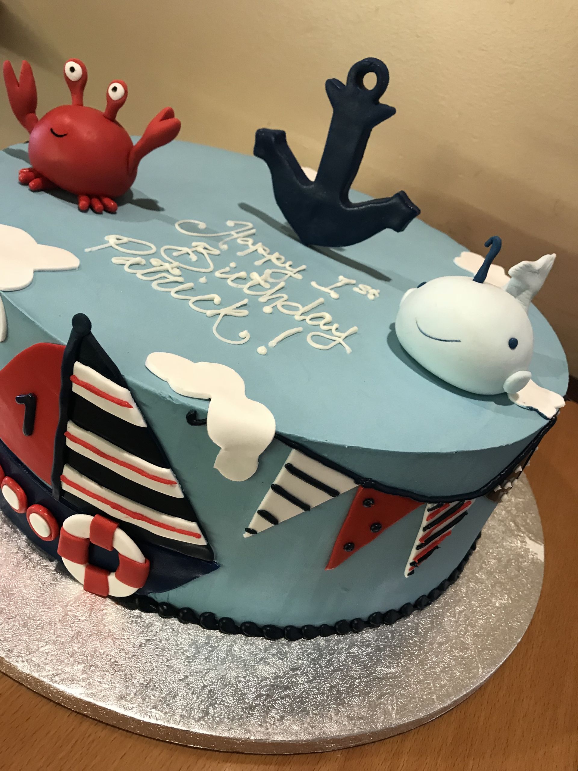a birthday cake with a crab whale and anchor on it