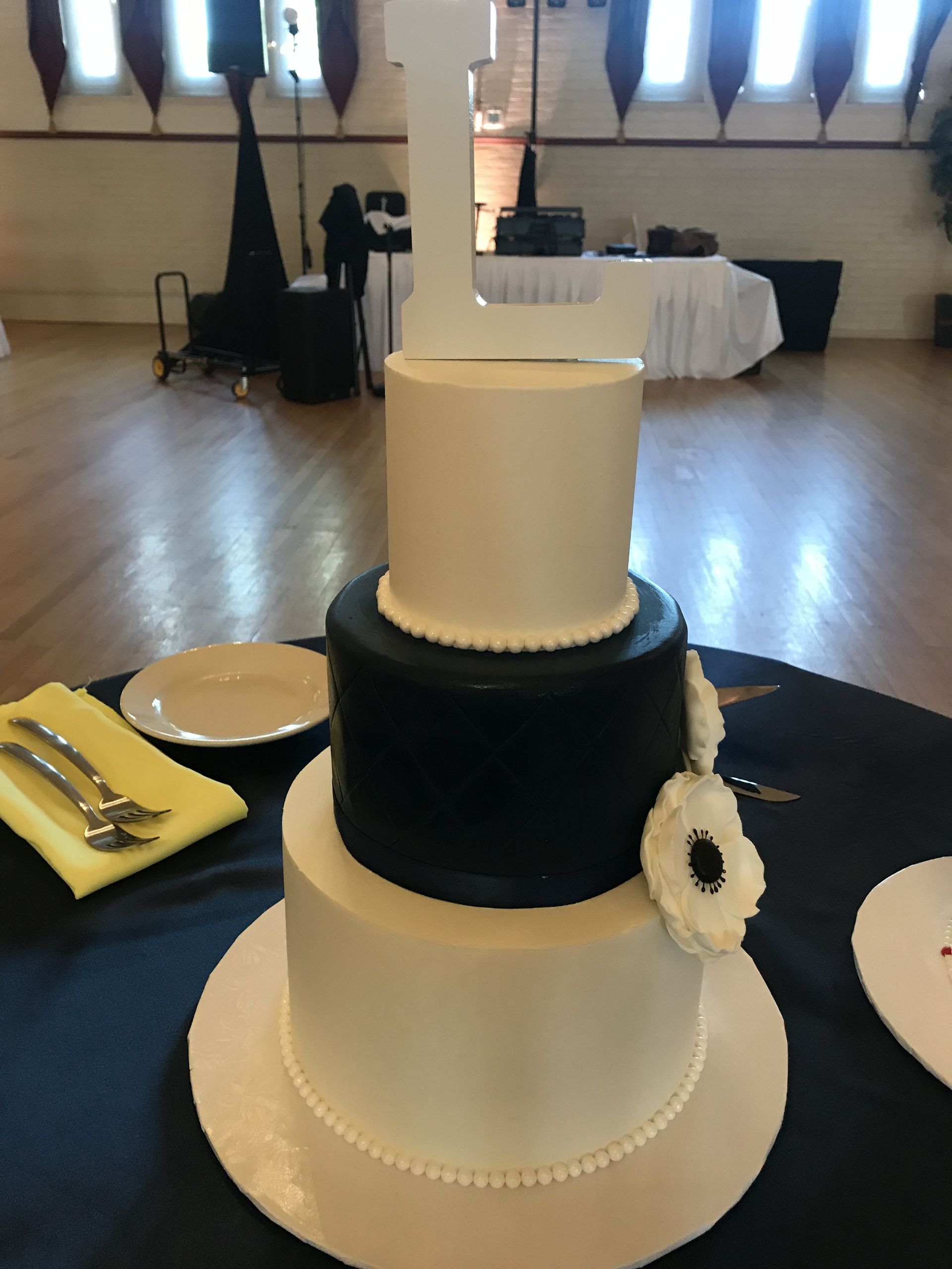 a black and white cake sits on a table