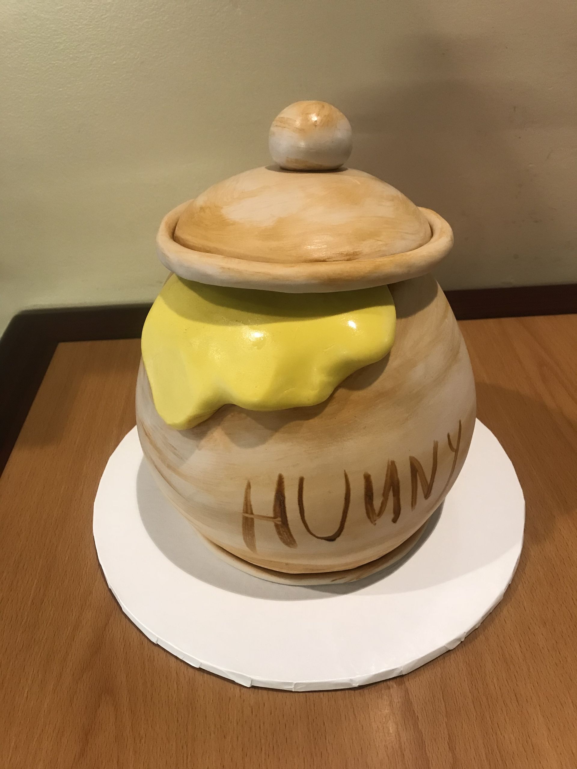 a honey pot with the word hunny on it