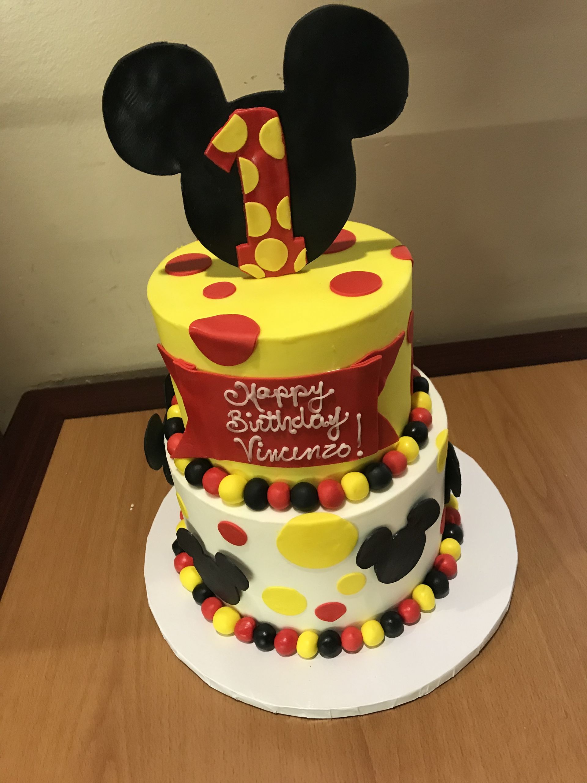 a mickey mouse birthday cake with the number 1 on top