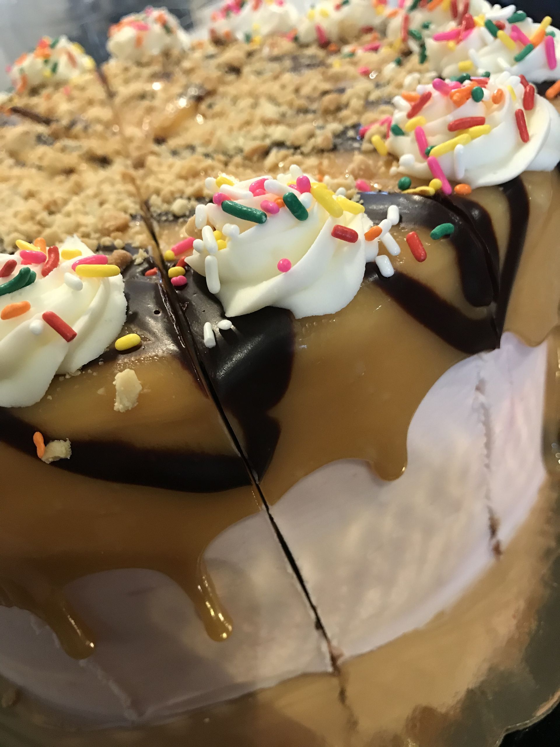 a close up of a cake with whipped cream and sprinkles