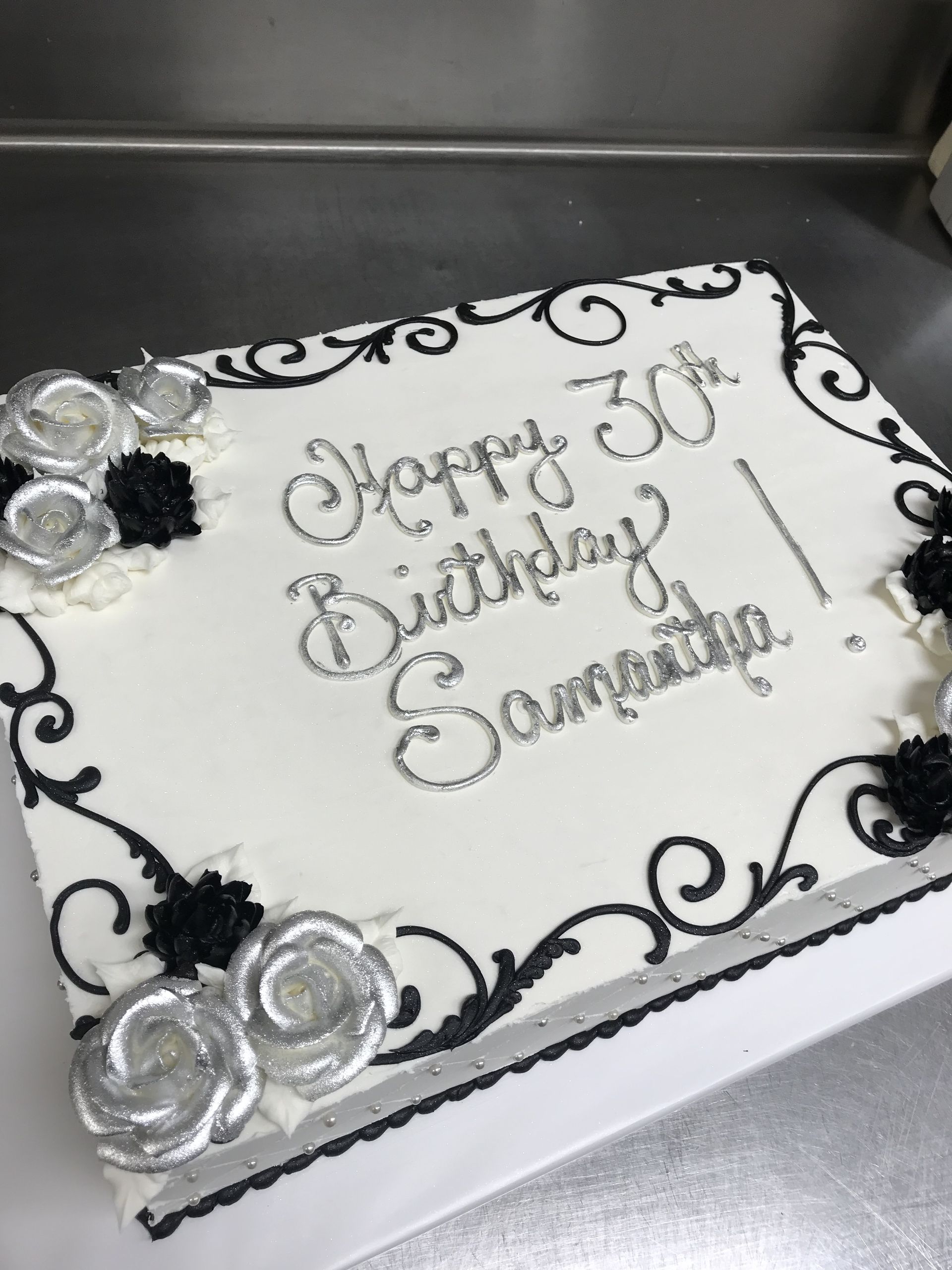 a black and white birthday cake says happy 30th birthday samantha
