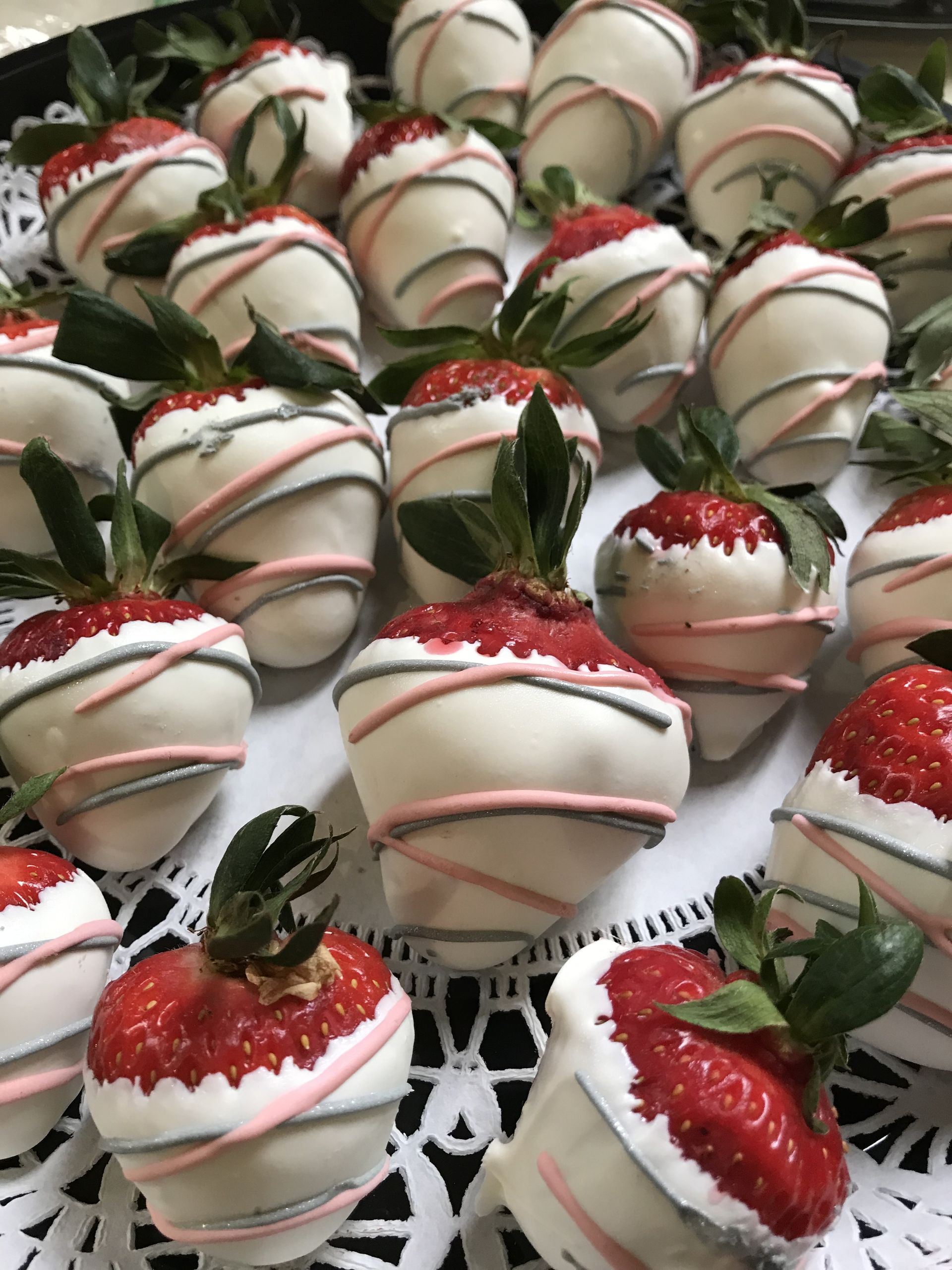 a bunch of chocolate covered strawberries on a plate