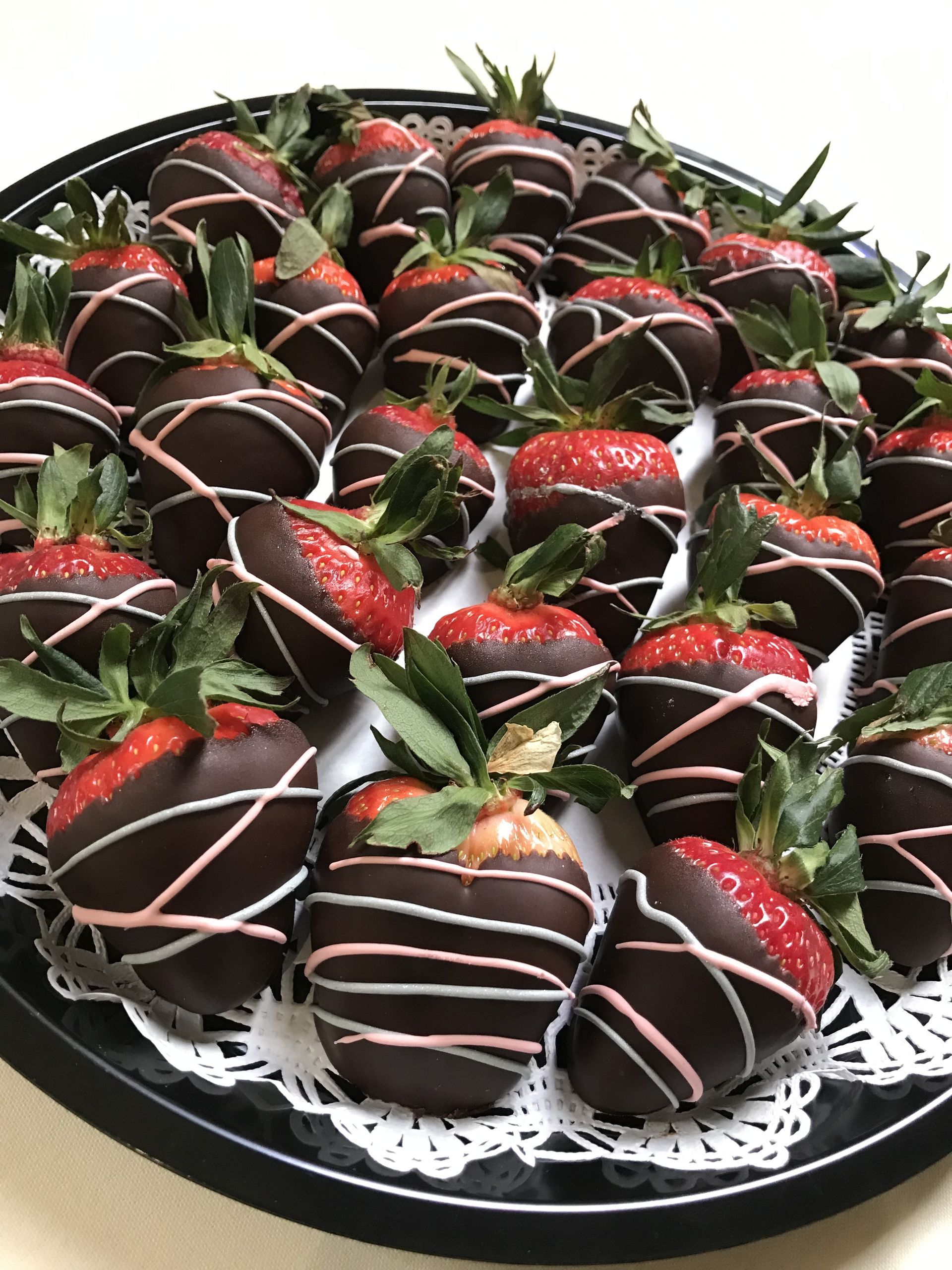 a tray of chocolate covered strawberries on a table