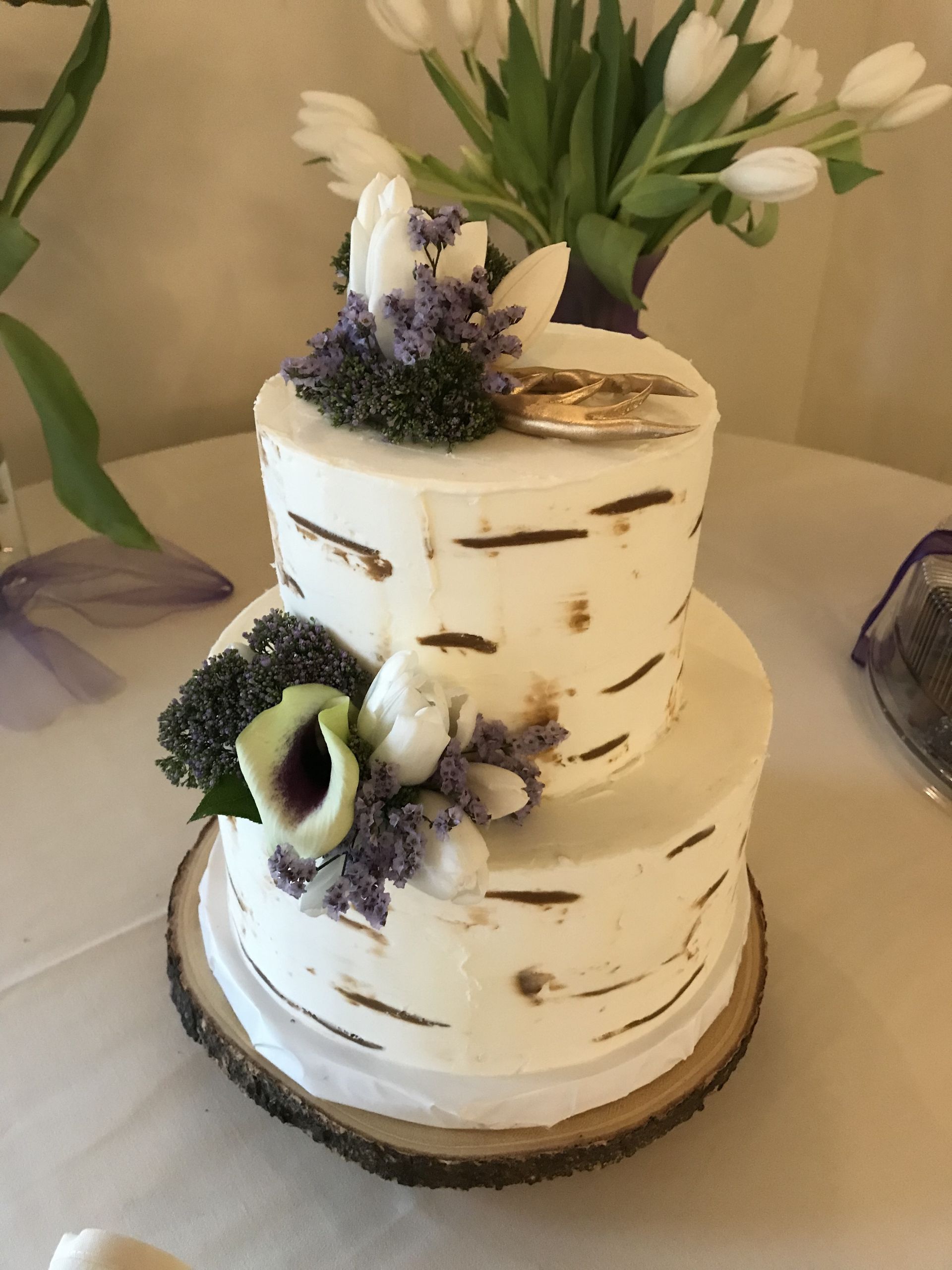 a white cake with purple flowers on top of it