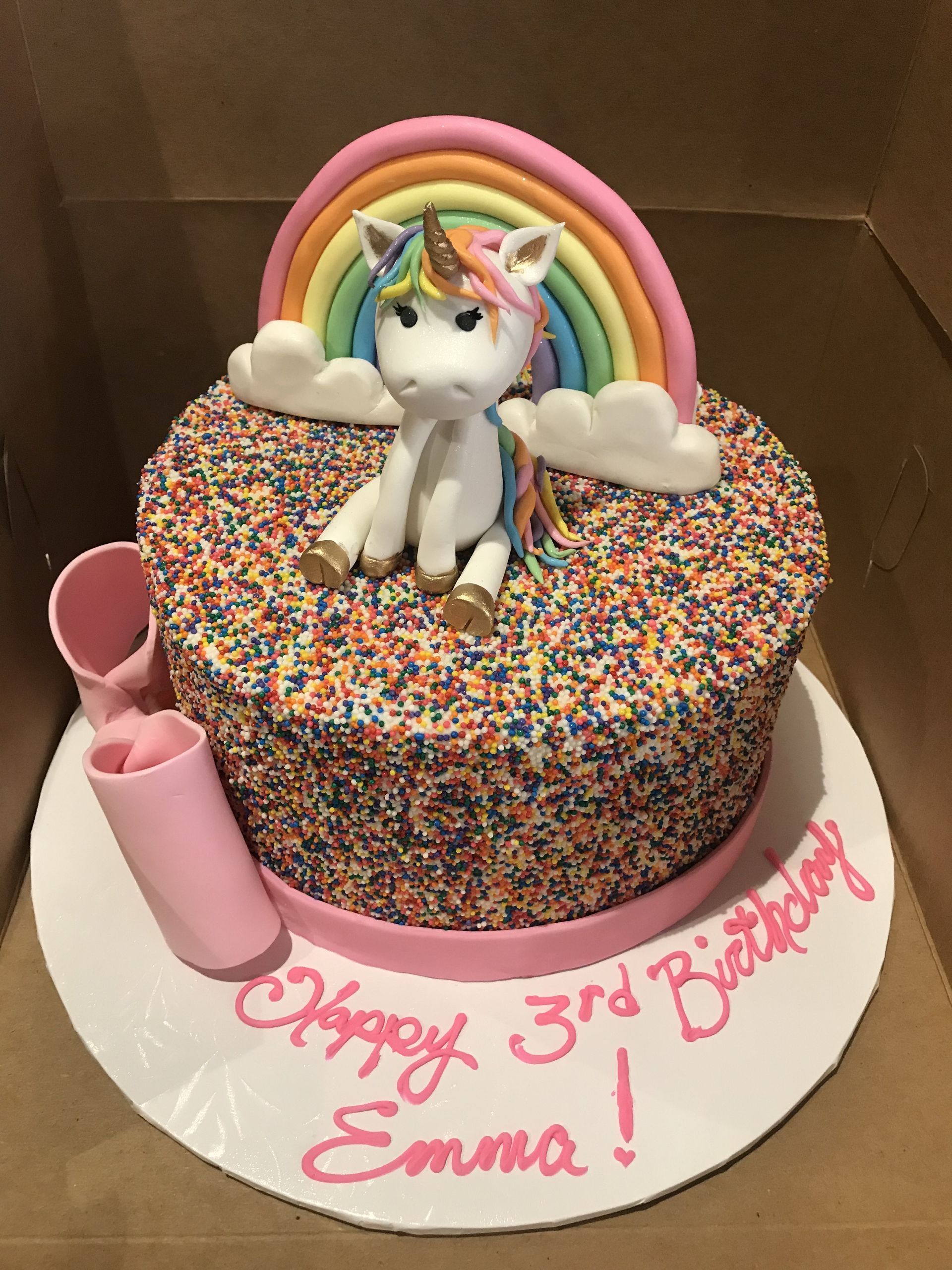 a birthday cake for emma with a unicorn on top