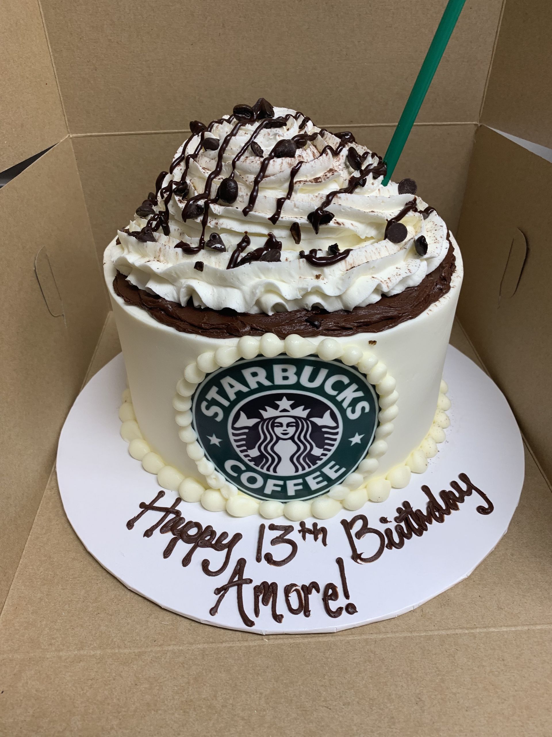 a starbucks birthday cake with whipped cream and chocolate chips