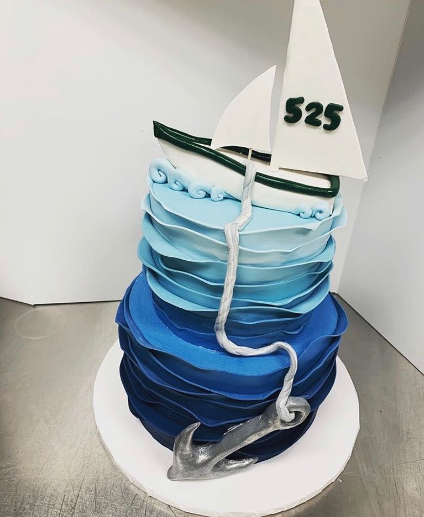 a cake with a sailboat and the number 525 on it