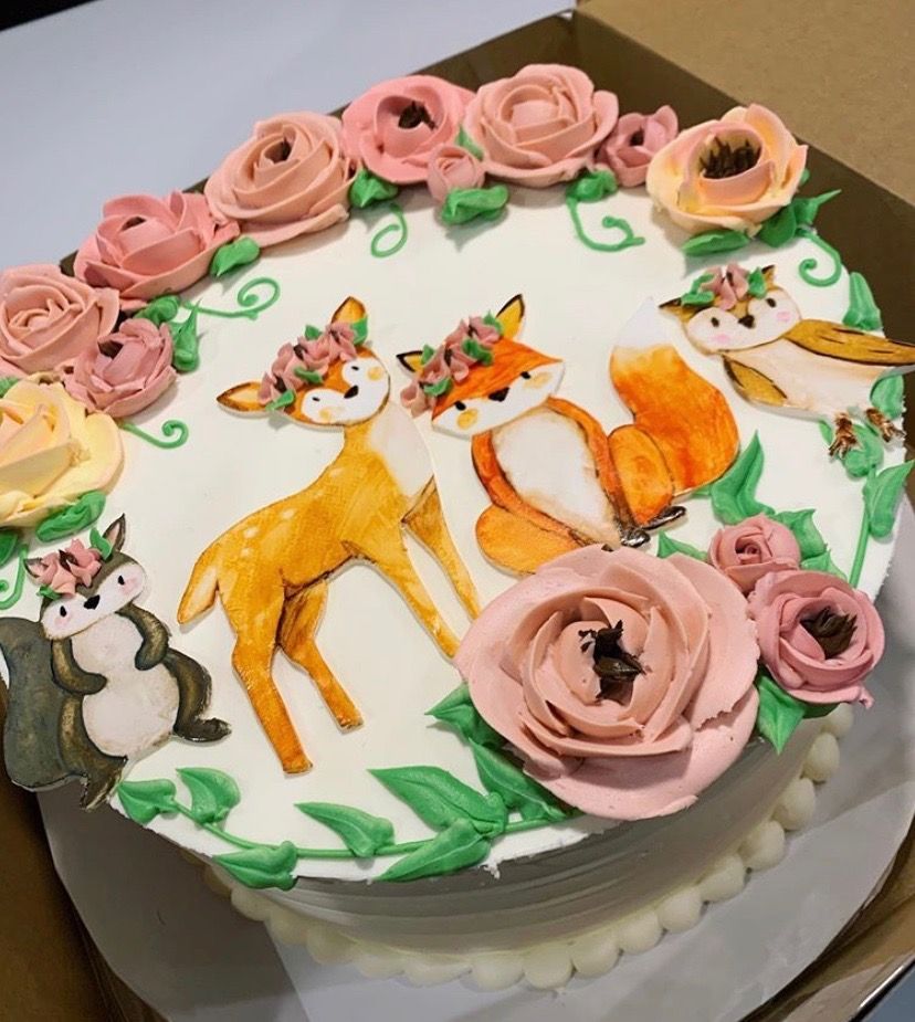 a cake with a deer fox and squirrel on it