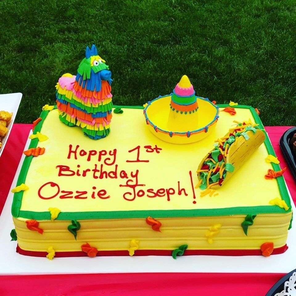 a yellow and green birthday cake for ozzie joseph