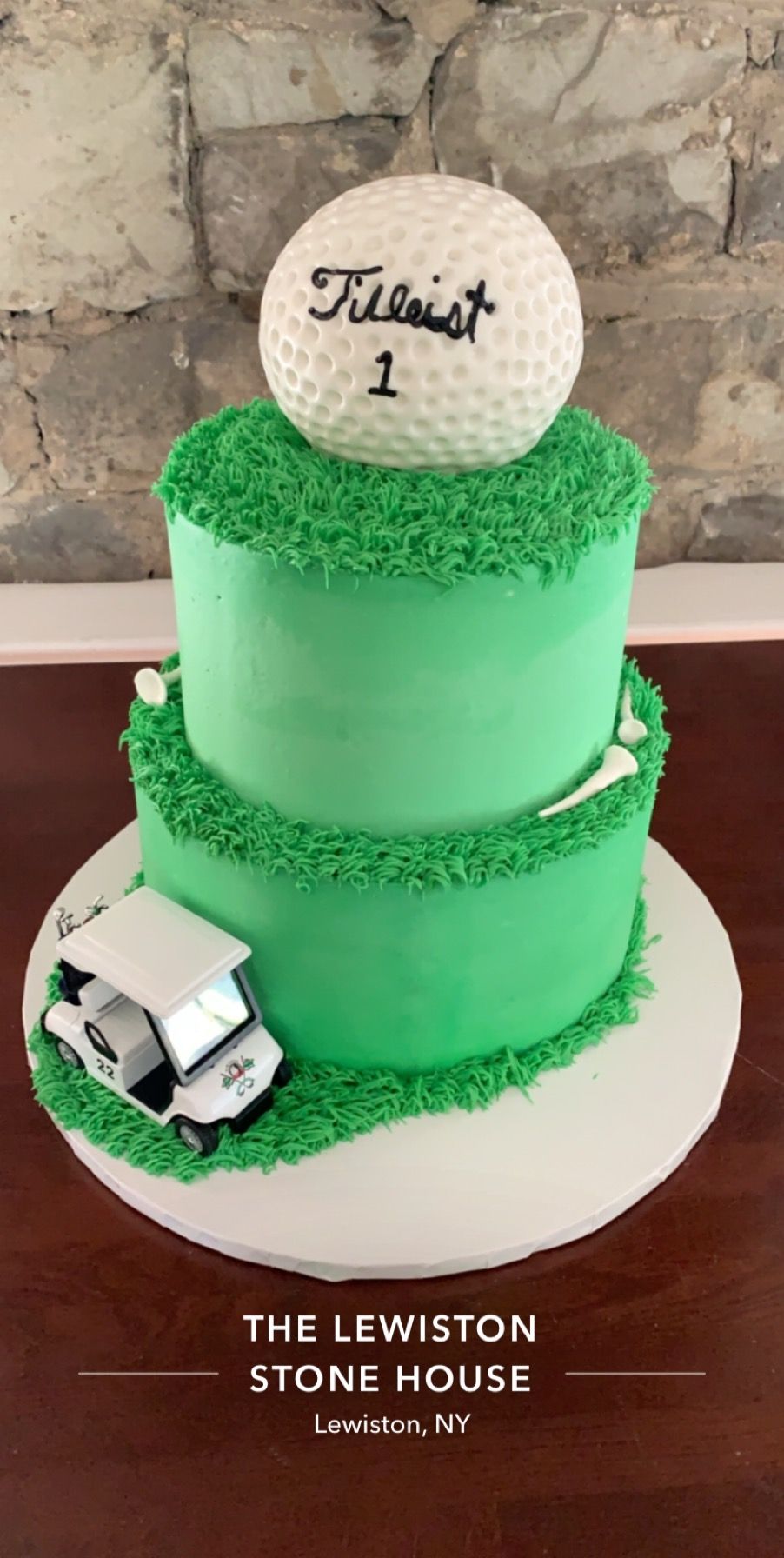 a green and white cake with a golf ball on top of it .